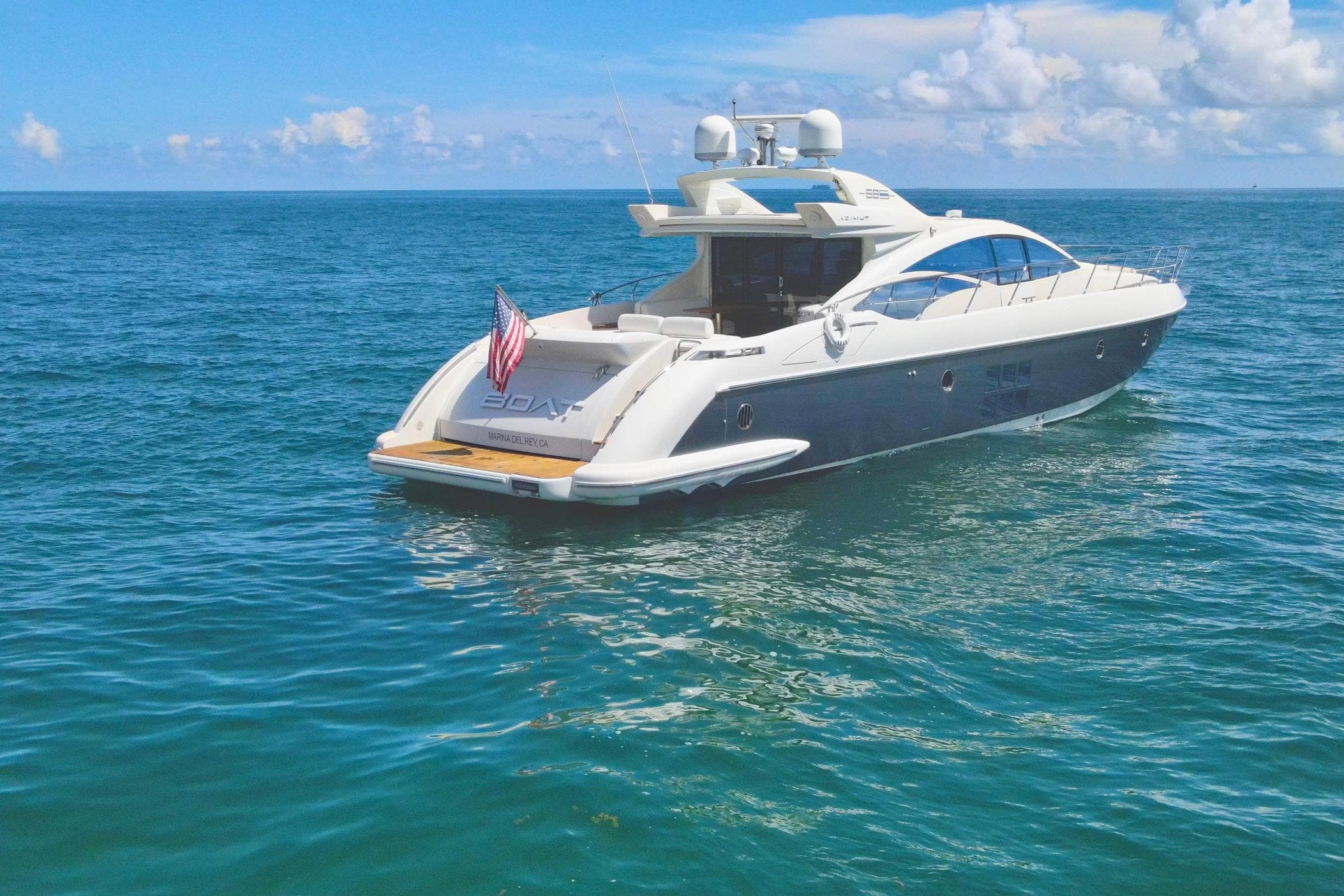 Luxury 2011 Azimut 68S yacht cruising on open sea under clear skies.