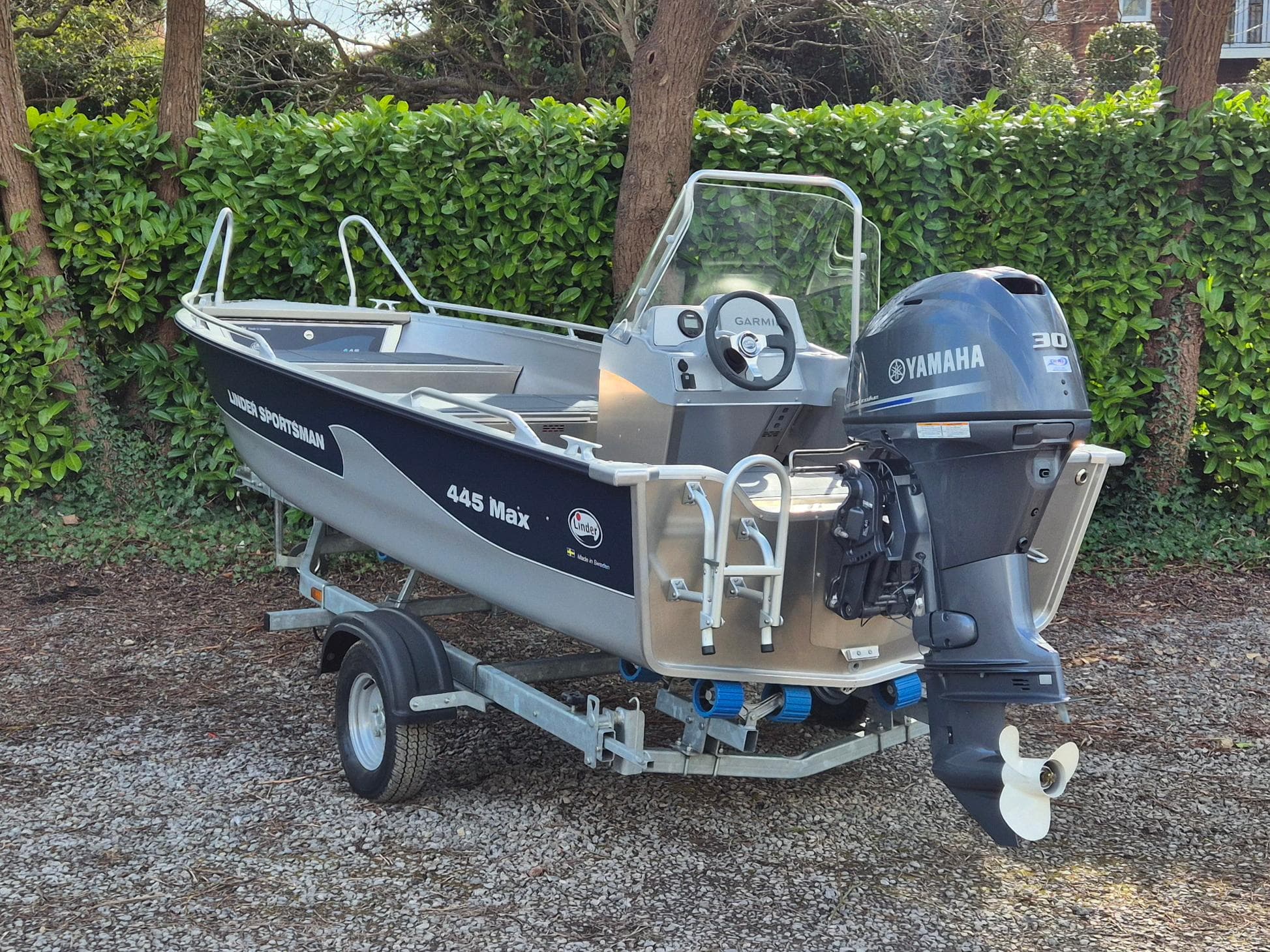 2022 Linder Sportsman 445 Max boat with Yamaha engine on trailer, parked outdoors.