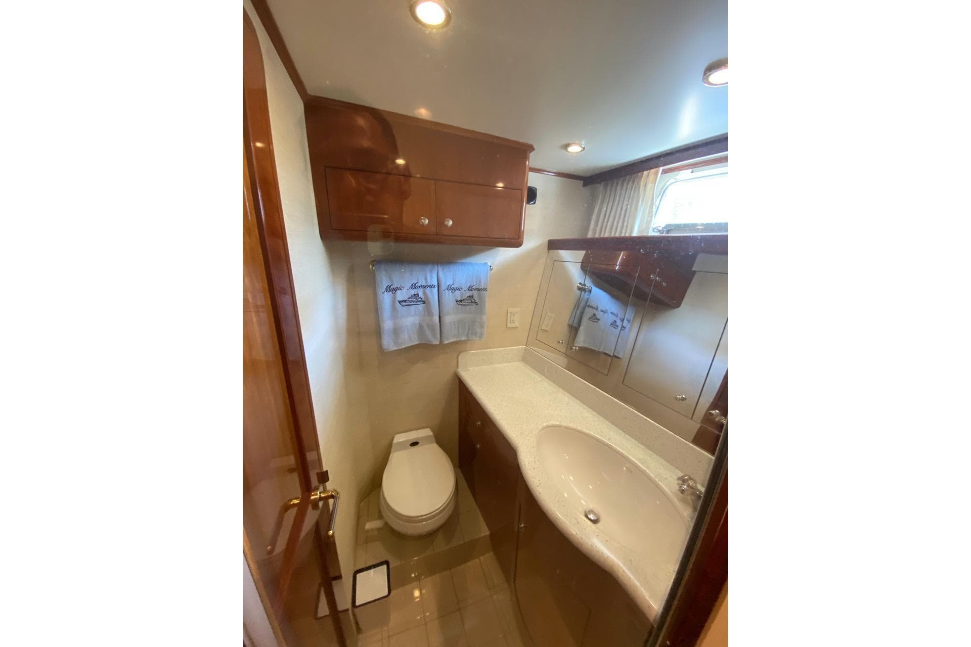 Luxurious bathroom in 2006 North Star Yachts 73 Cockpit Motoryacht, featuring elegant wood cabinetry.