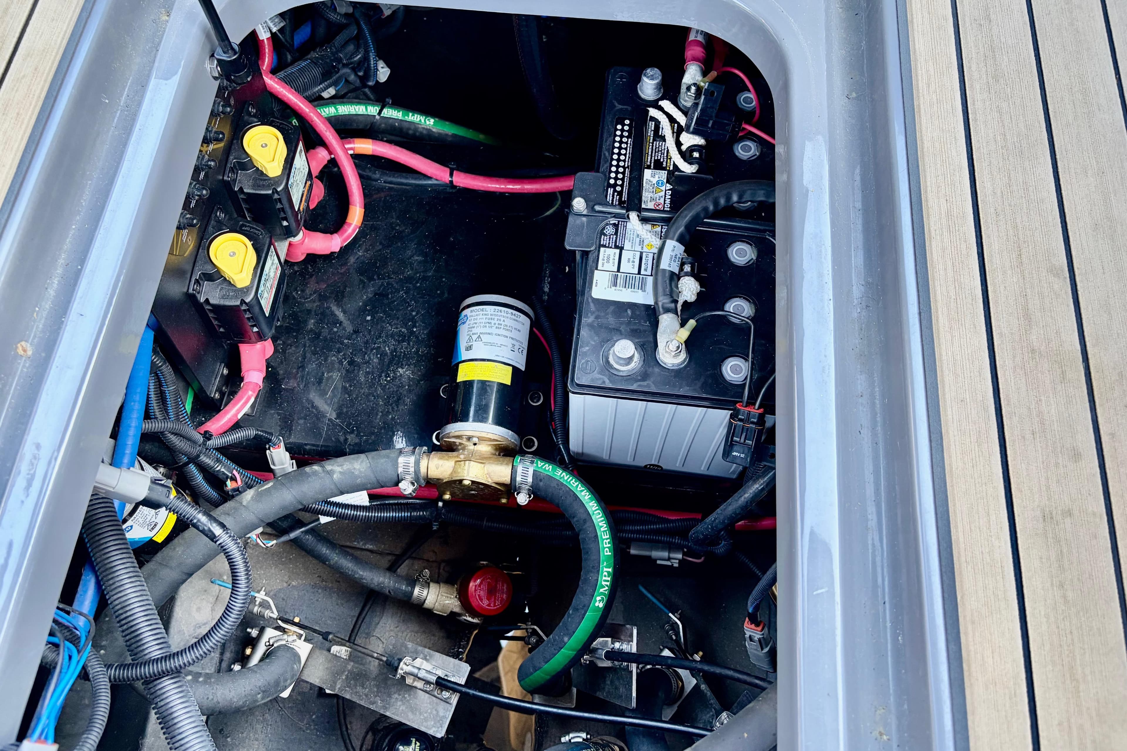 Engine compartment of 2020 Nautique Super Air Nautique G23 Paragon with visible wiring and battery.
