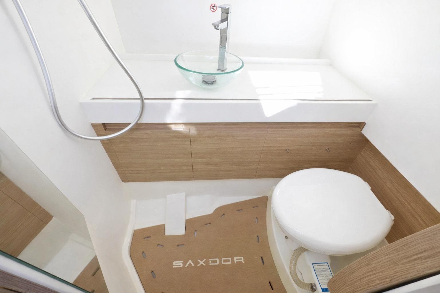 Modern bathroom in 2025 Saxdor 400 GTO boat, featuring sleek fixtures and wood accents.