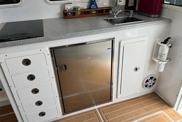 Interior of 2000 Northern Bay 38 boat with kitchenette, sink, and storage.