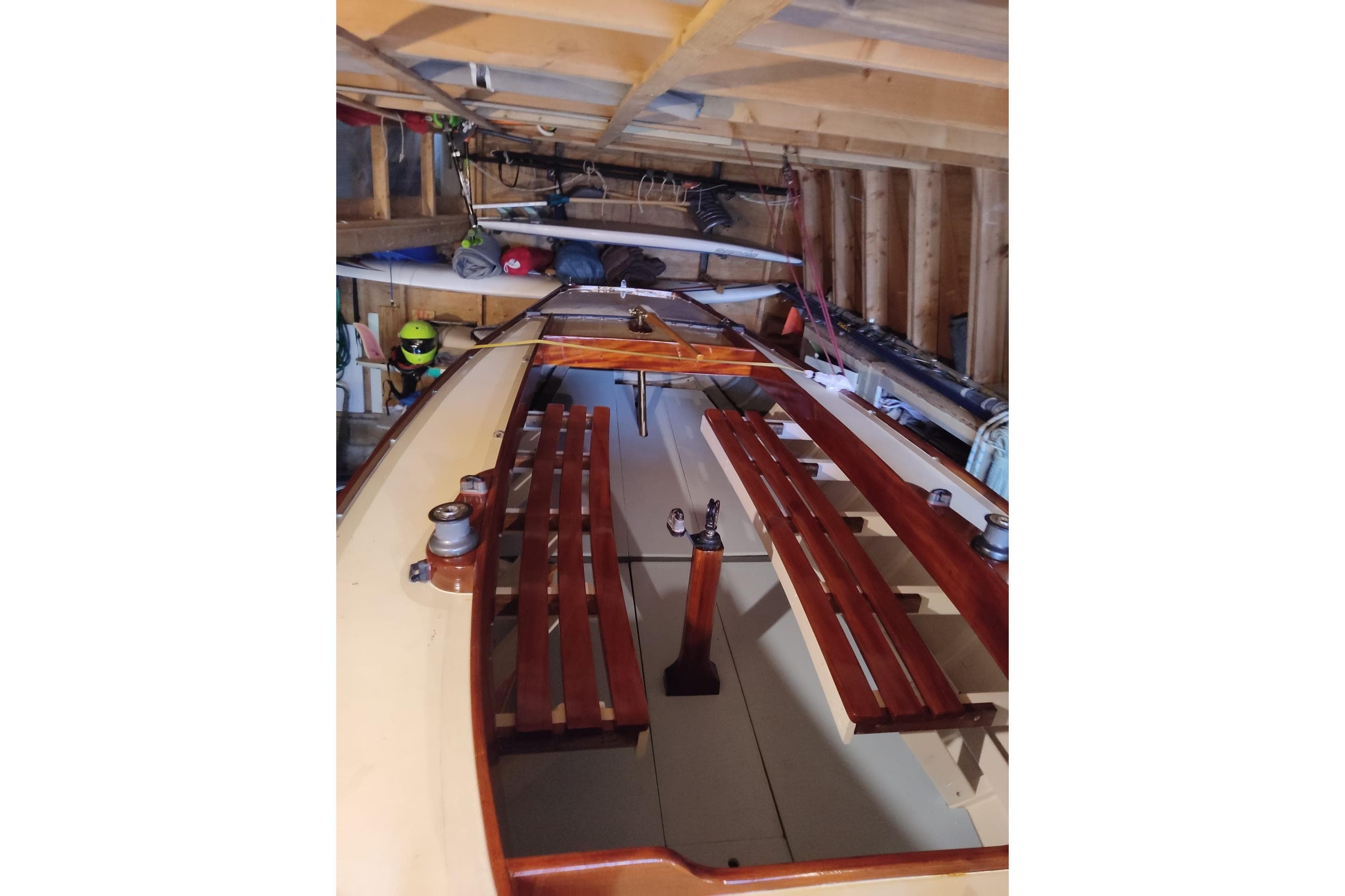 Interior view of a Bluenose sailboat stored in a wooden garage.
