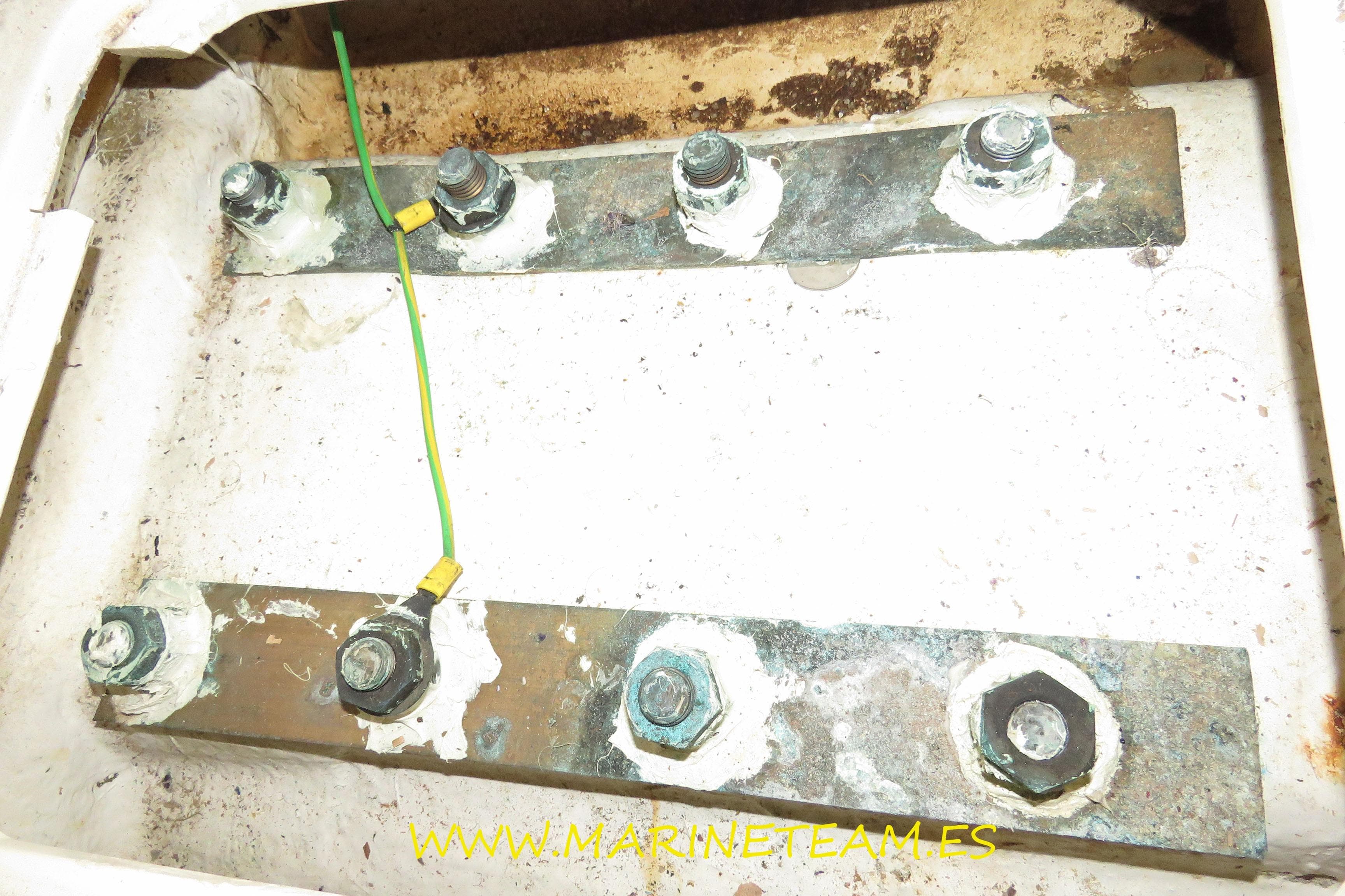 Electrical grounding system on a 1995 Princess 60 yacht with visible bolts and wiring.