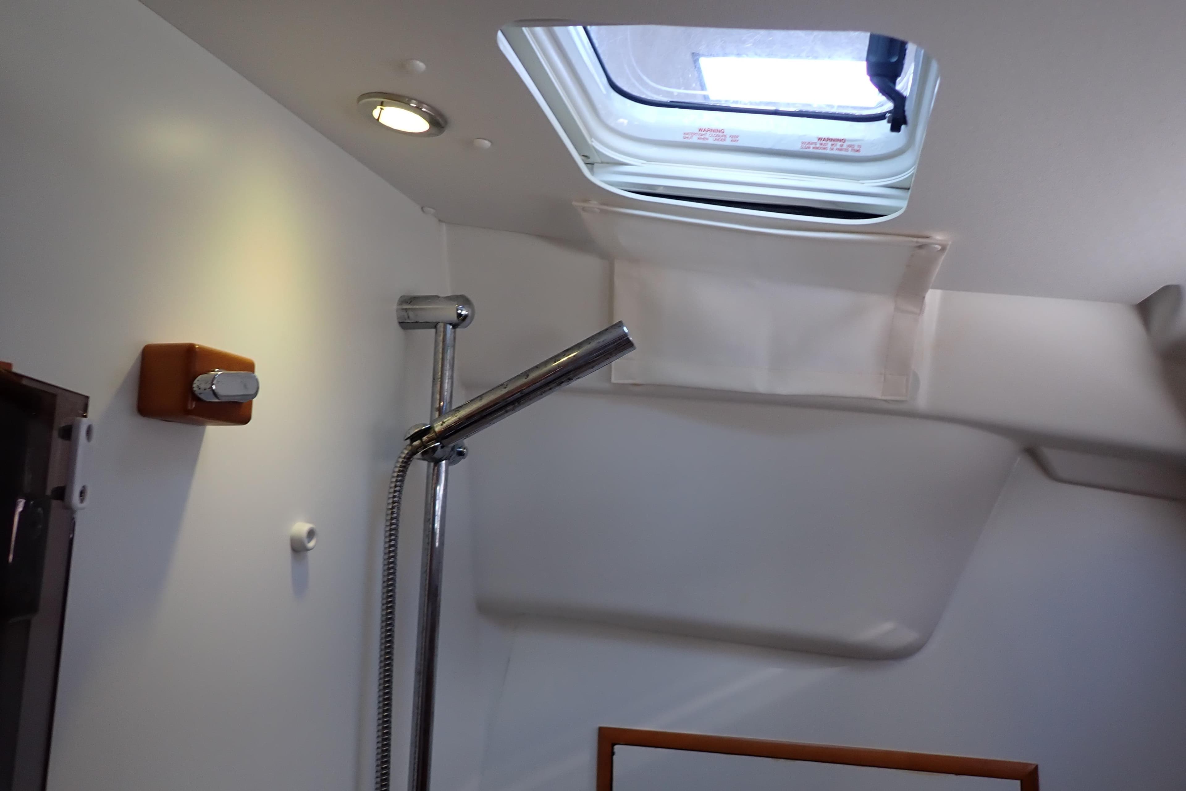 Interior of 2018 Jeanneau Sun Odyssey 389 yacht, featuring a shower and skylight.