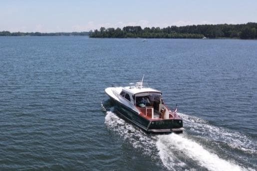 Cruising on a serene river under a clear sky.