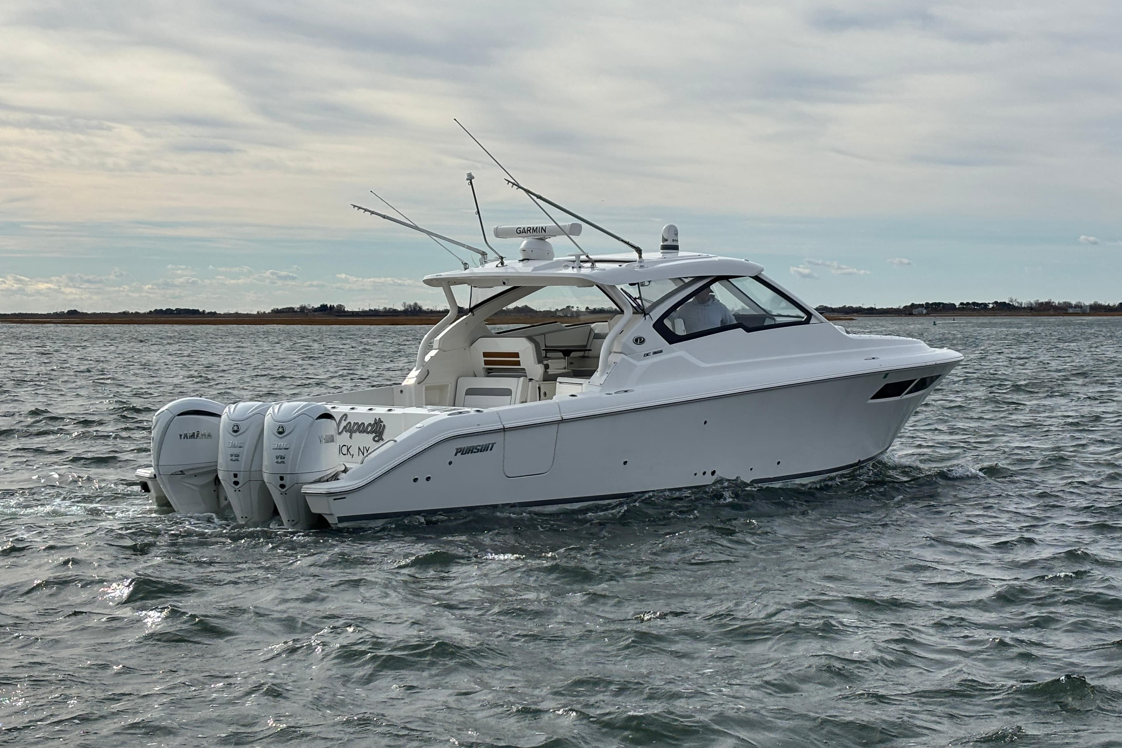 2022 Pursuit DC 365 Dual Console boat cruising on open water.