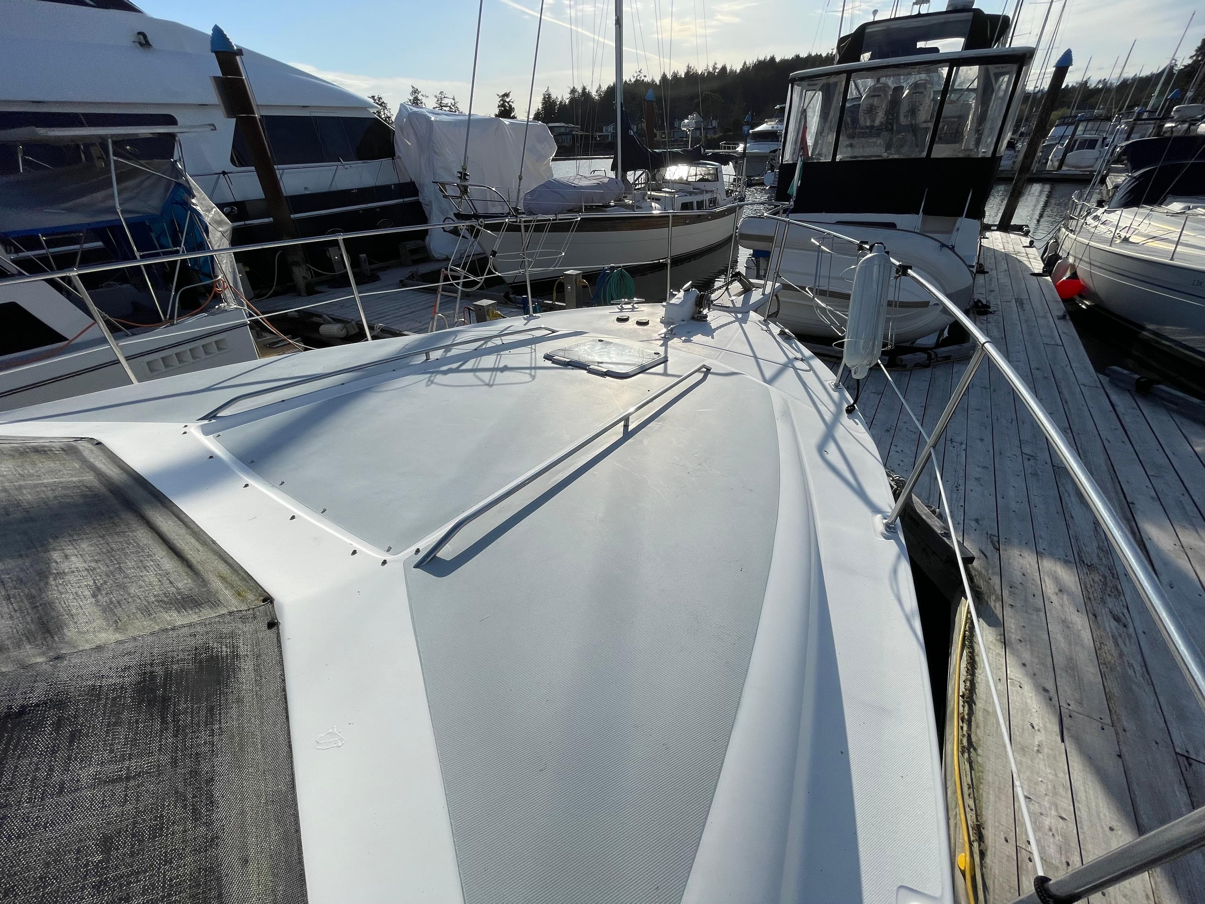 1991 Bayliner 4387 yacht docked at marina, showcasing spacious deck and sleek design.
