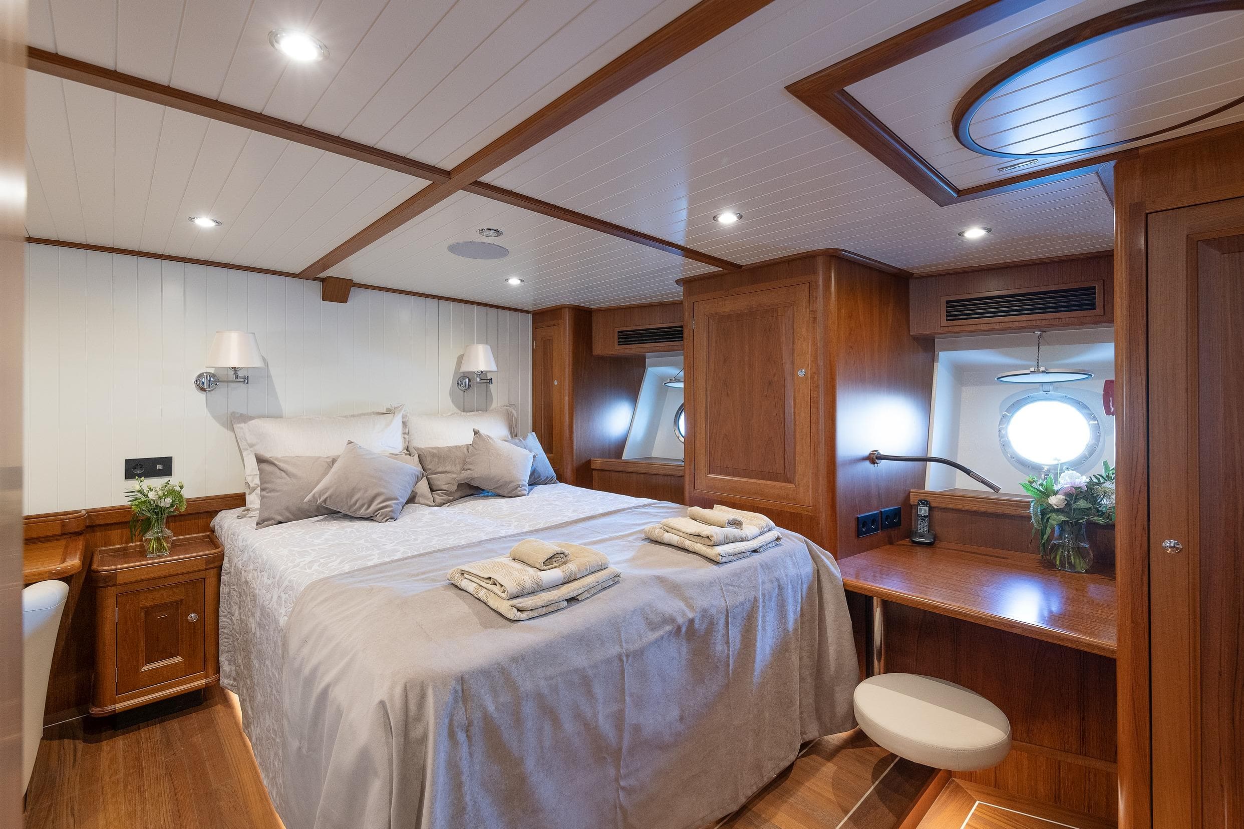 Luxurious 2022 Ridas Custom Yacht bedroom with elegant wood finish and cozy bedding.