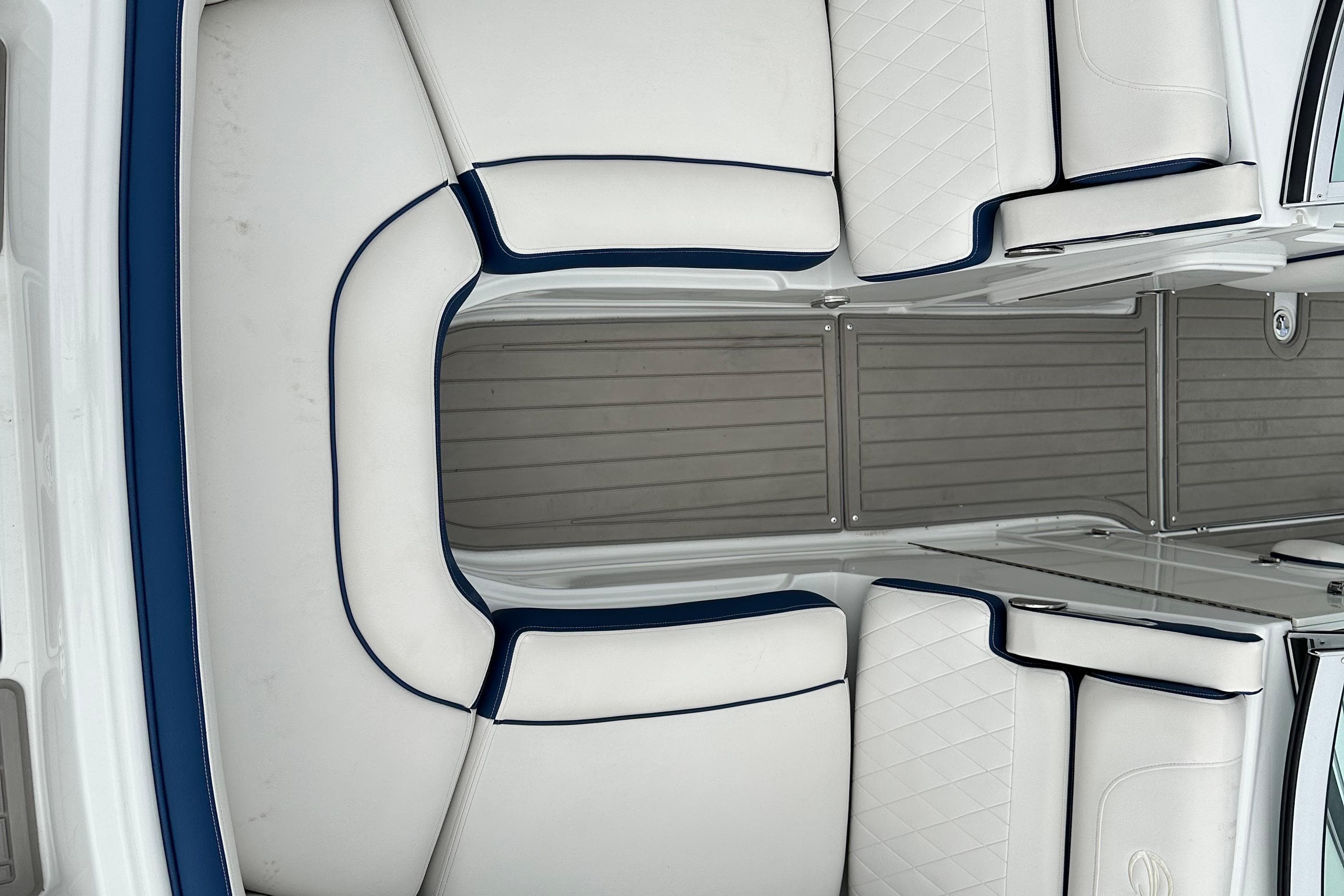 2021 Crownline Eclipse E235 SURF boat interior with white and blue seating.