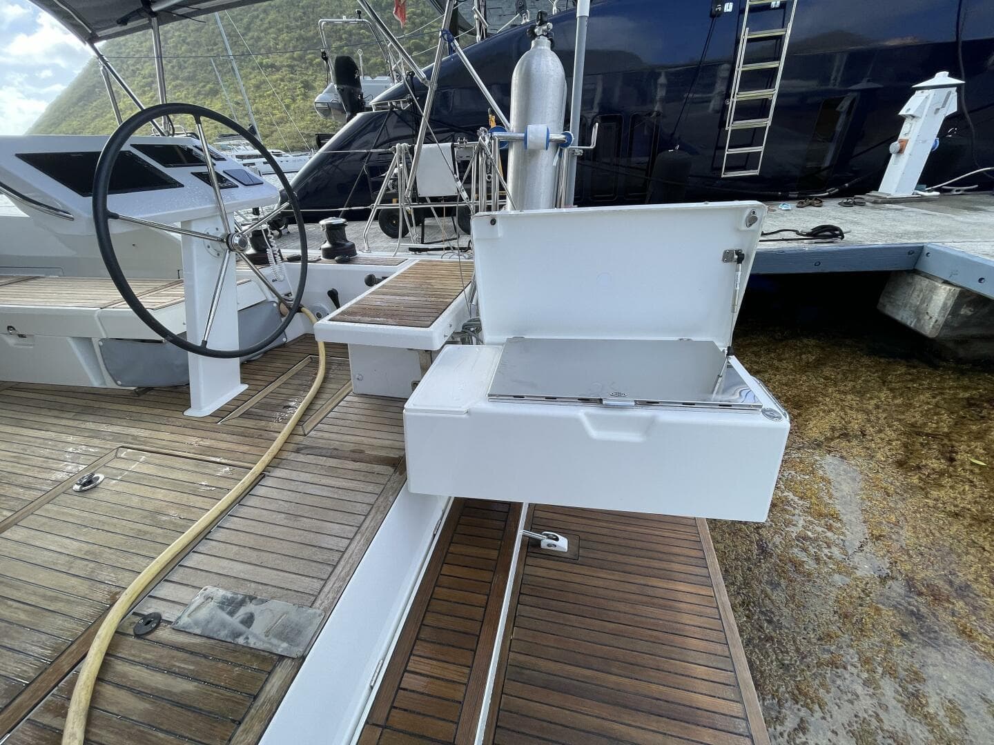 Beneteau Oceanis 46.1 yacht deck with steering wheel and open storage compartment, 2020 model.