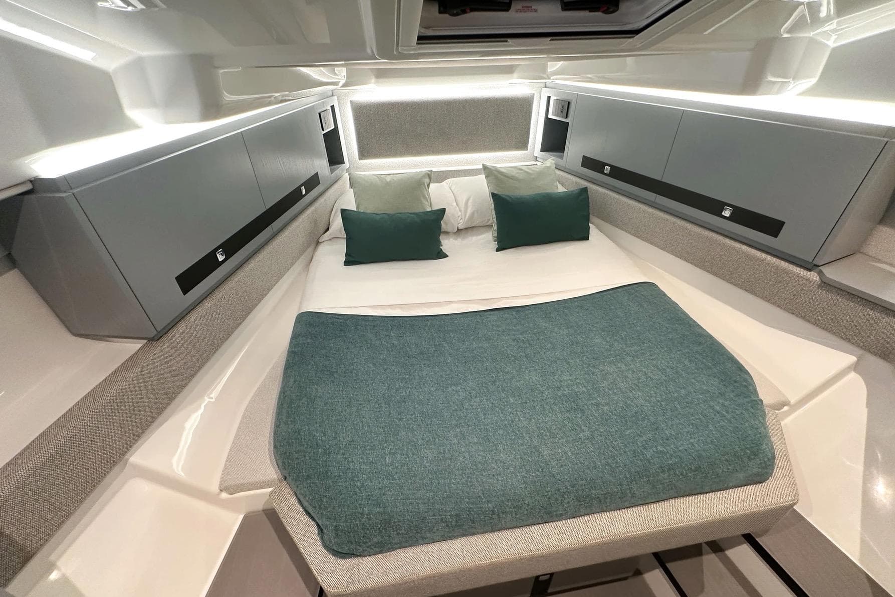 Luxurious cabin interior of Marco E-MOTION 44 yacht, 2026 model, with modern bedding and lighting.