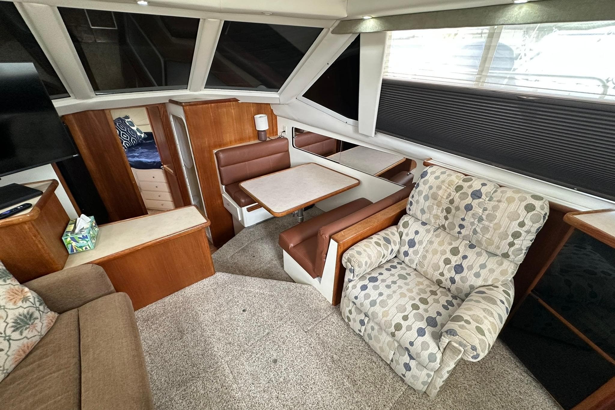 Interior of 1997 Carver 355 Aft Cabin Motor Yacht with cozy seating and dining area.