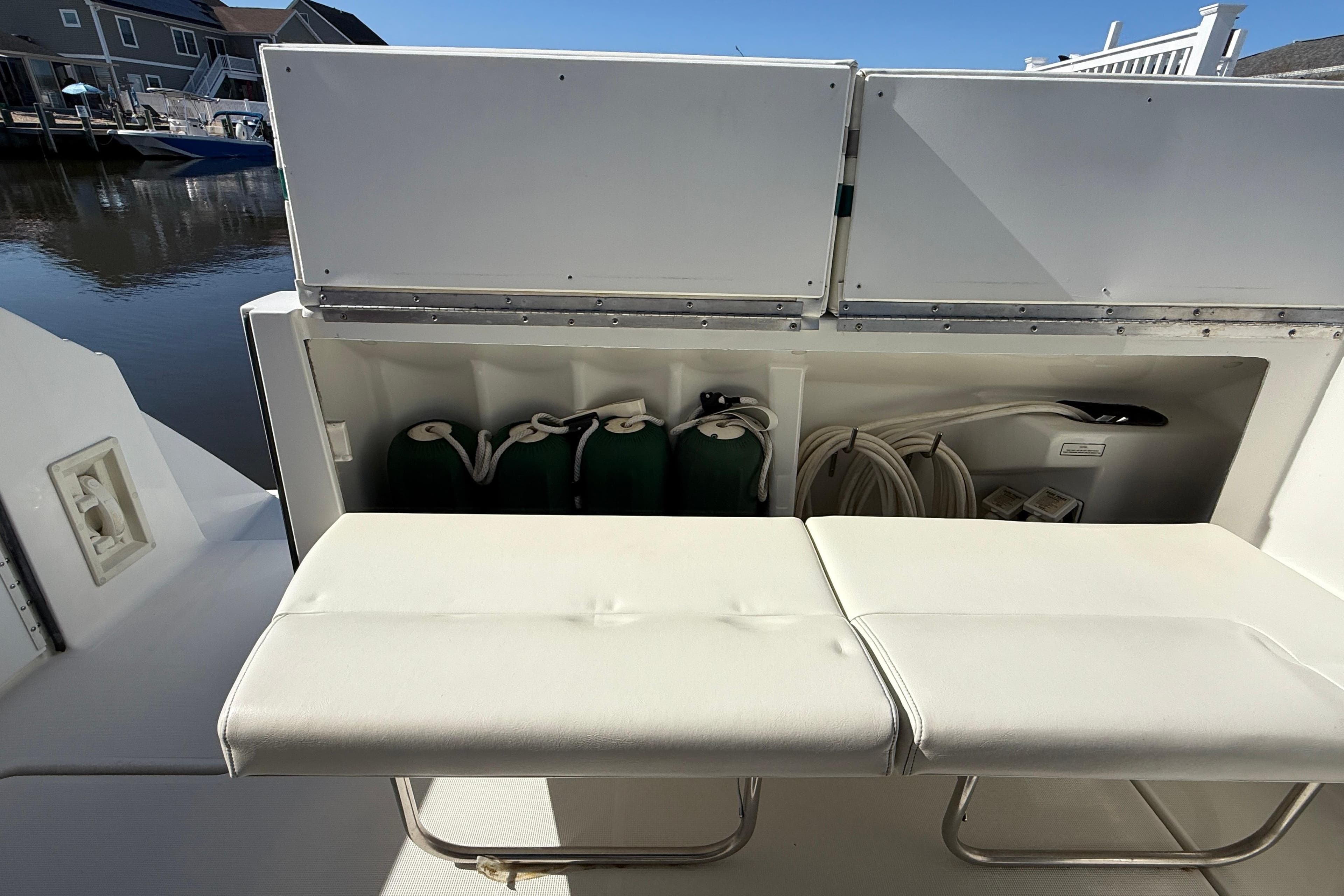 1998 Formula 34 Performance Cruiser storage area with white seating and dock view.