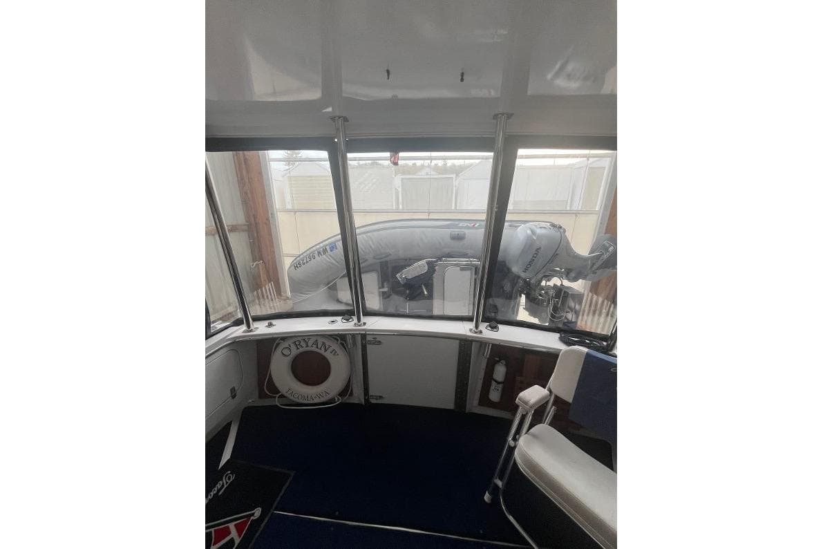 1976 Uniflite 32 Sport Sedan interior with view of inflatable boat outside.