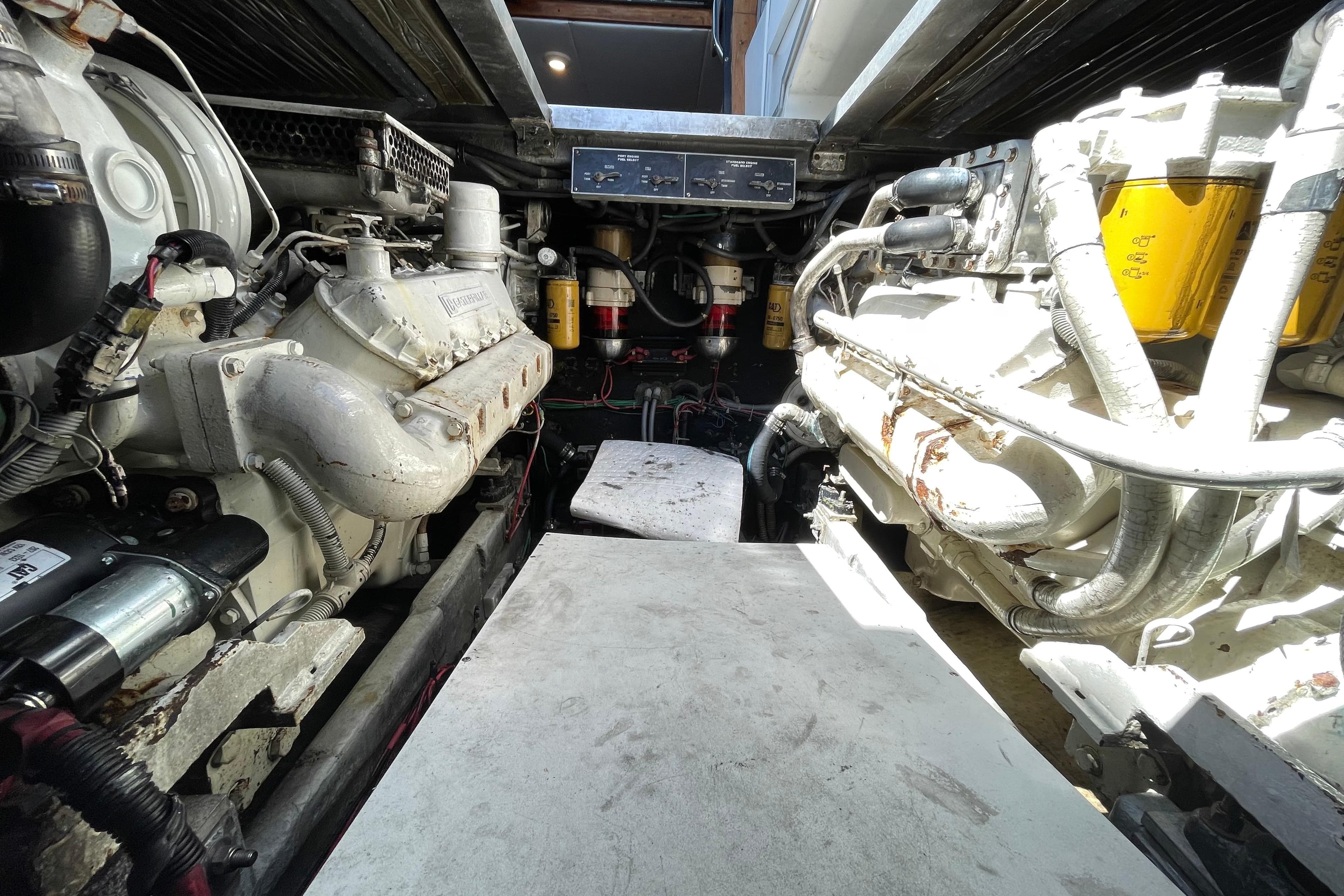 Engine room of a 1990 Sea Ray 390 Express Cruiser, showcasing dual engines and mechanical components.