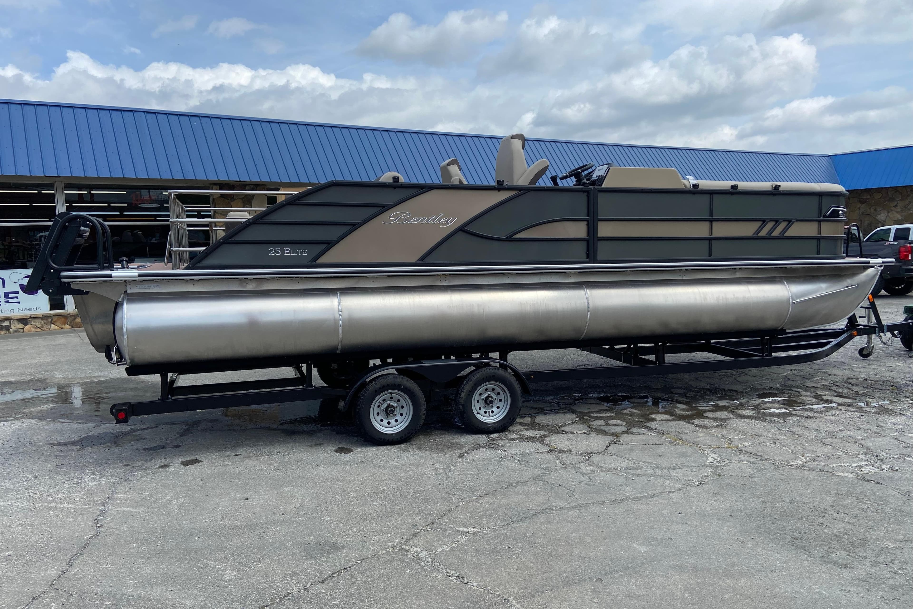 2026 Bentley Pontoons 25 Elite Swingback on trailer, side view.