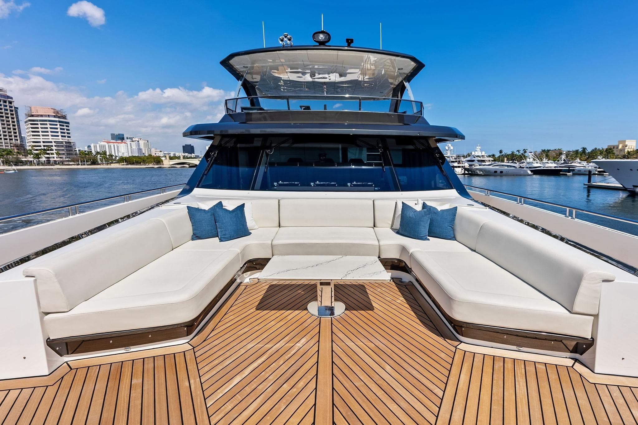 Luxurious 2024 Ocean Alexander 35 Revolution yacht with spacious deck seating and scenic marina view.