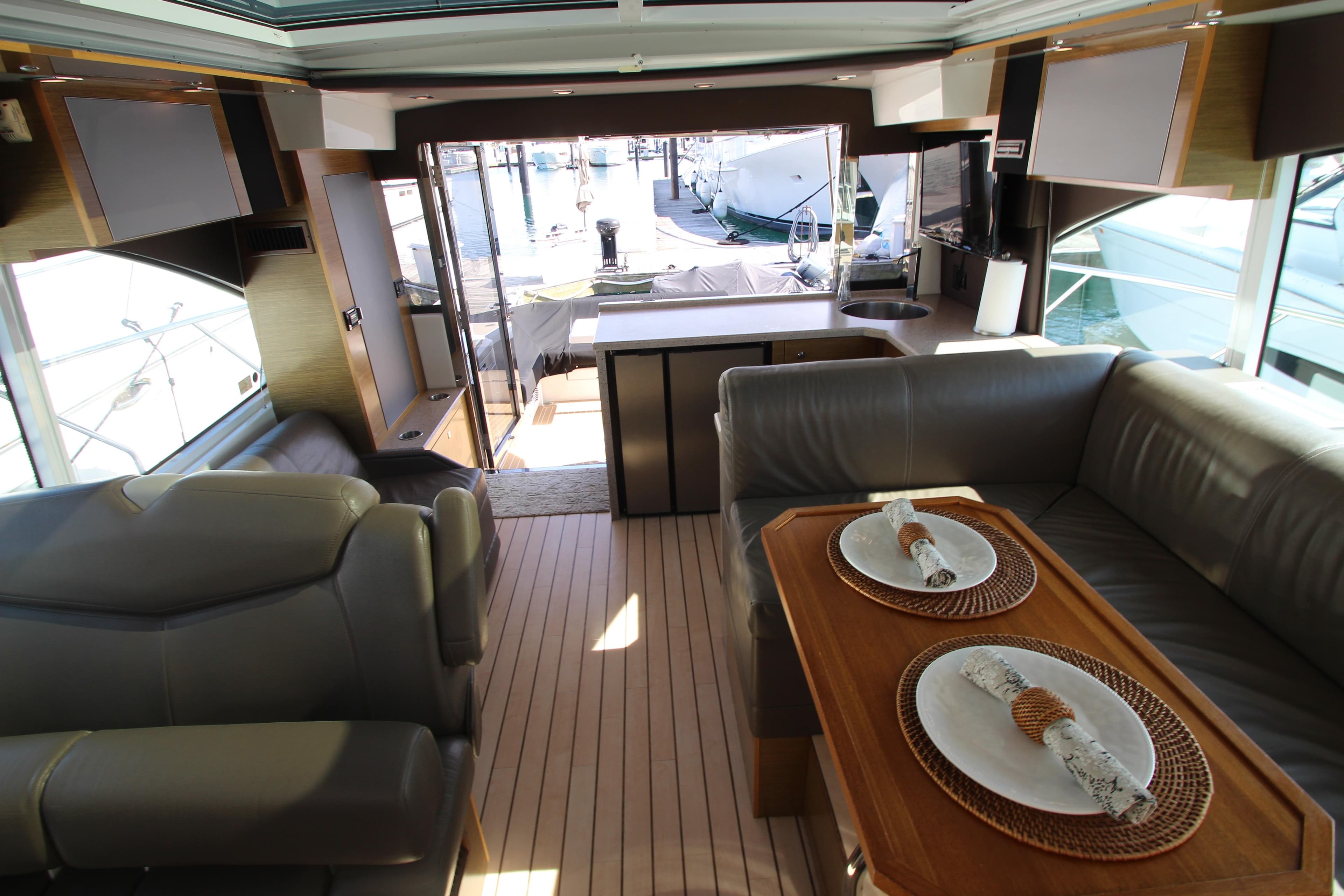 Luxurious interior of 2014 Cruisers Yachts 45 Cantius with elegant seating and dining area.