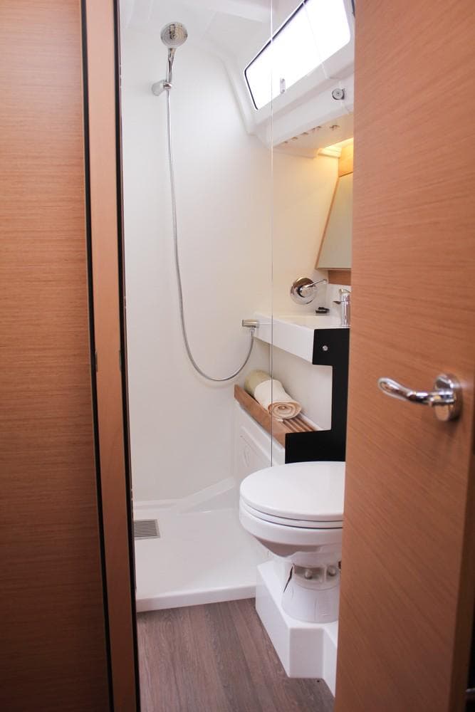 2025 Jeanneau Sun Odyssey 440 bathroom with modern fixtures and wooden accents.