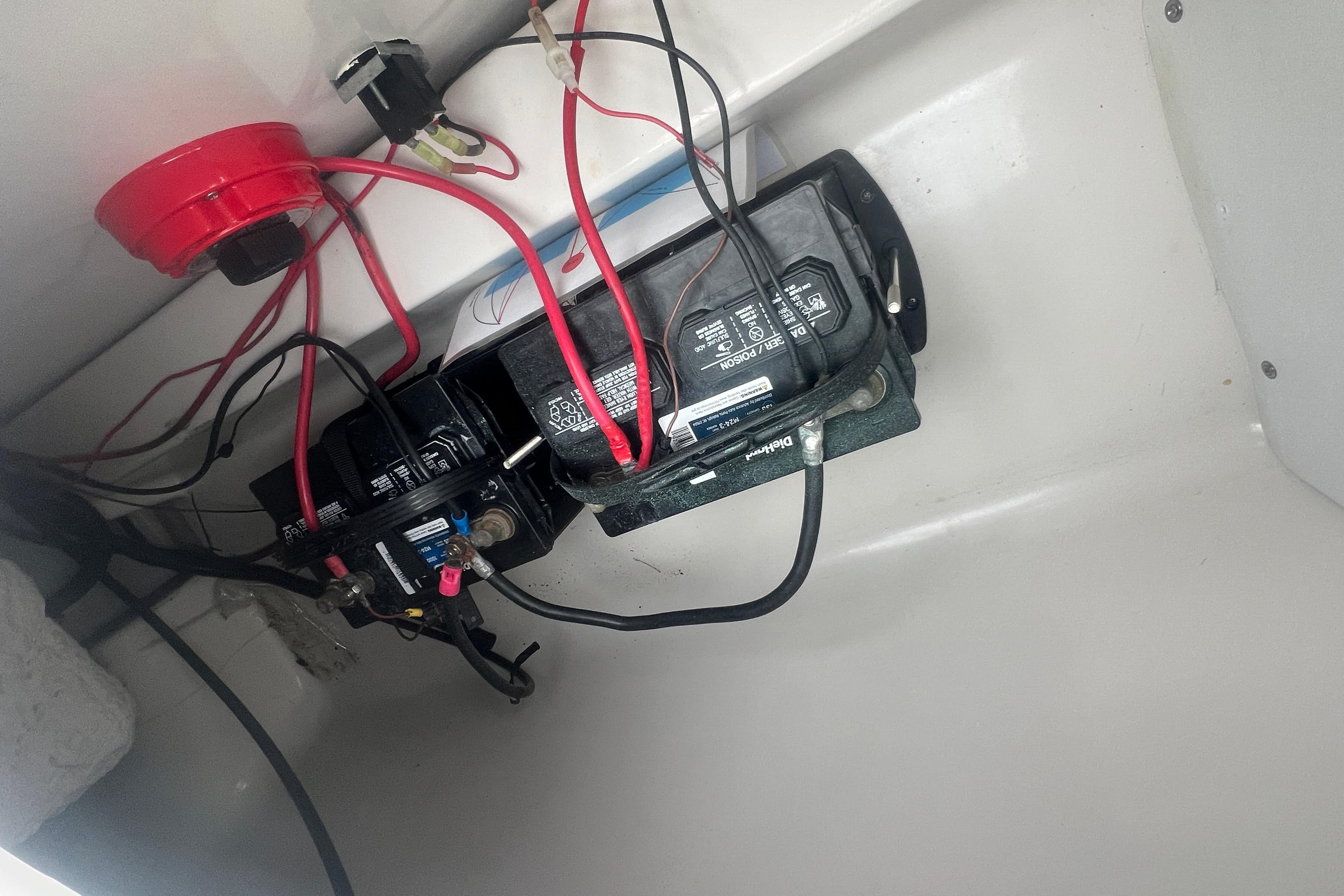 2005 Tahoe 234 boat battery compartment with wiring and connections.