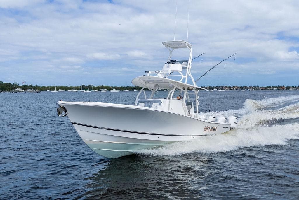 2018 Regulator 41 boat cruising on open water under a partly cloudy sky.