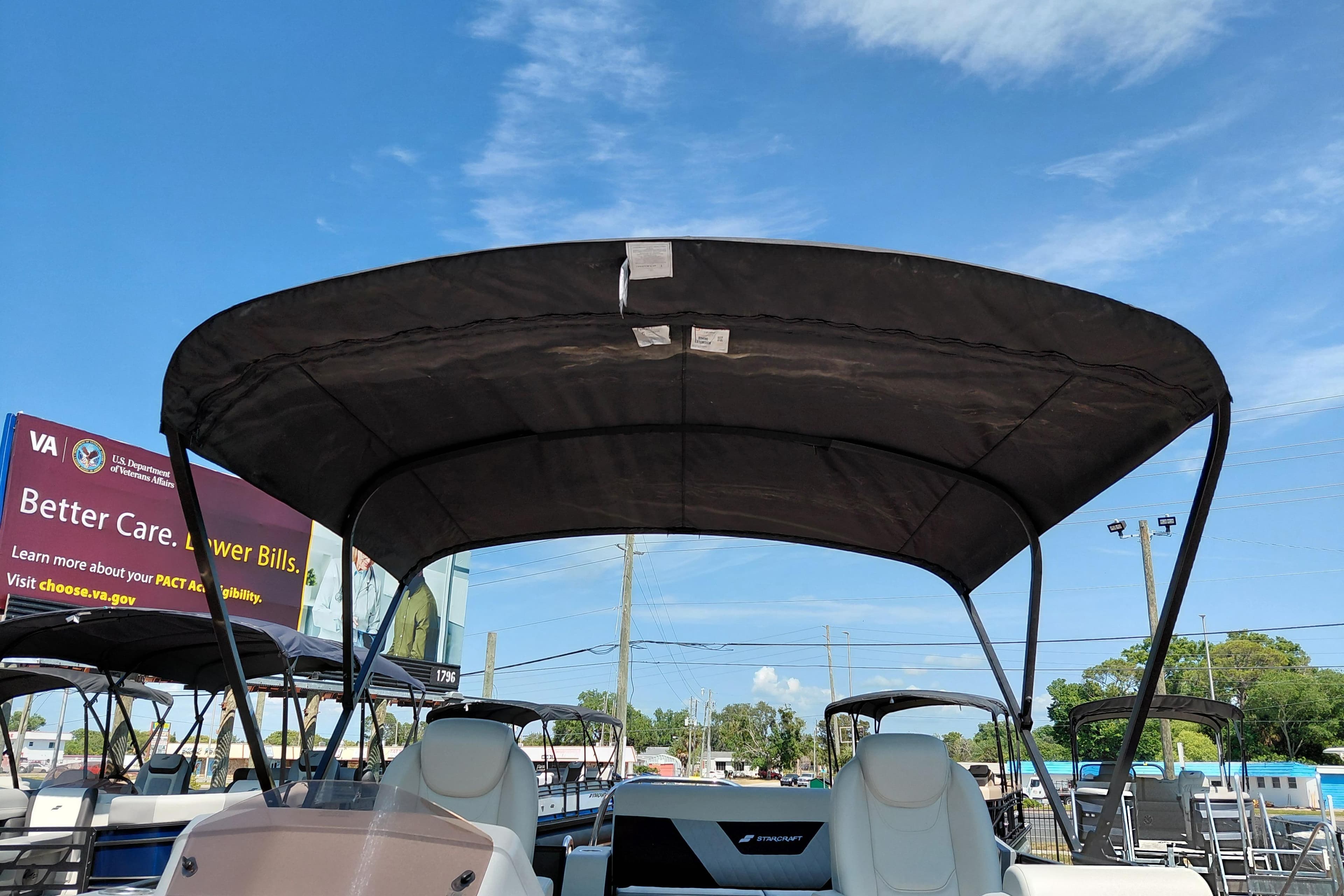 2026 Starcraft VX 24 Q DH boat with canopy under clear blue sky.