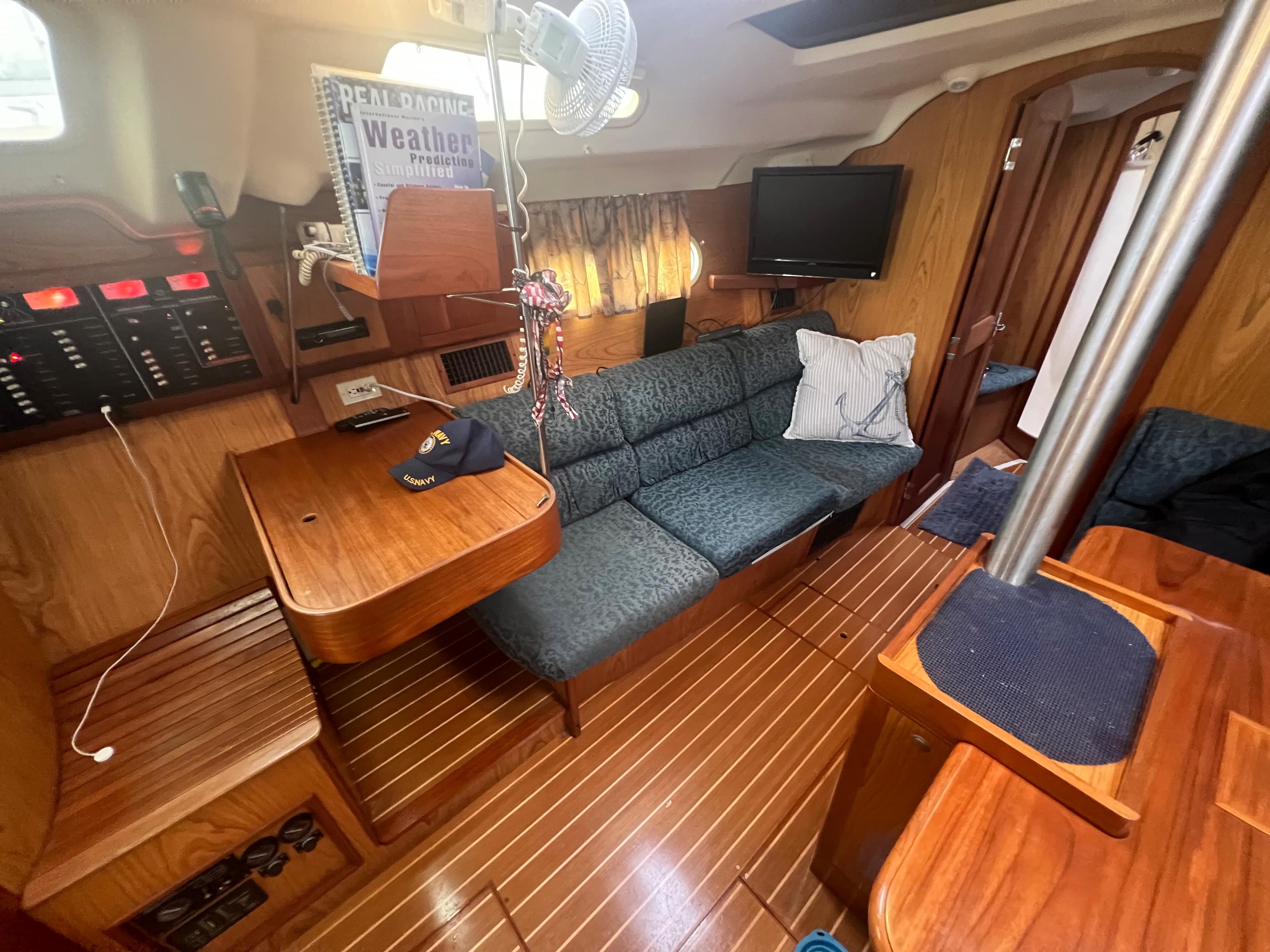 Interior of a 2000 Hunter 410 sailboat with wood finish and cozy seating area.