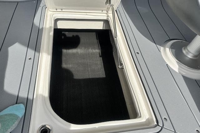 Open storage compartment on 2026 Chaparral 6 SSX boat deck.