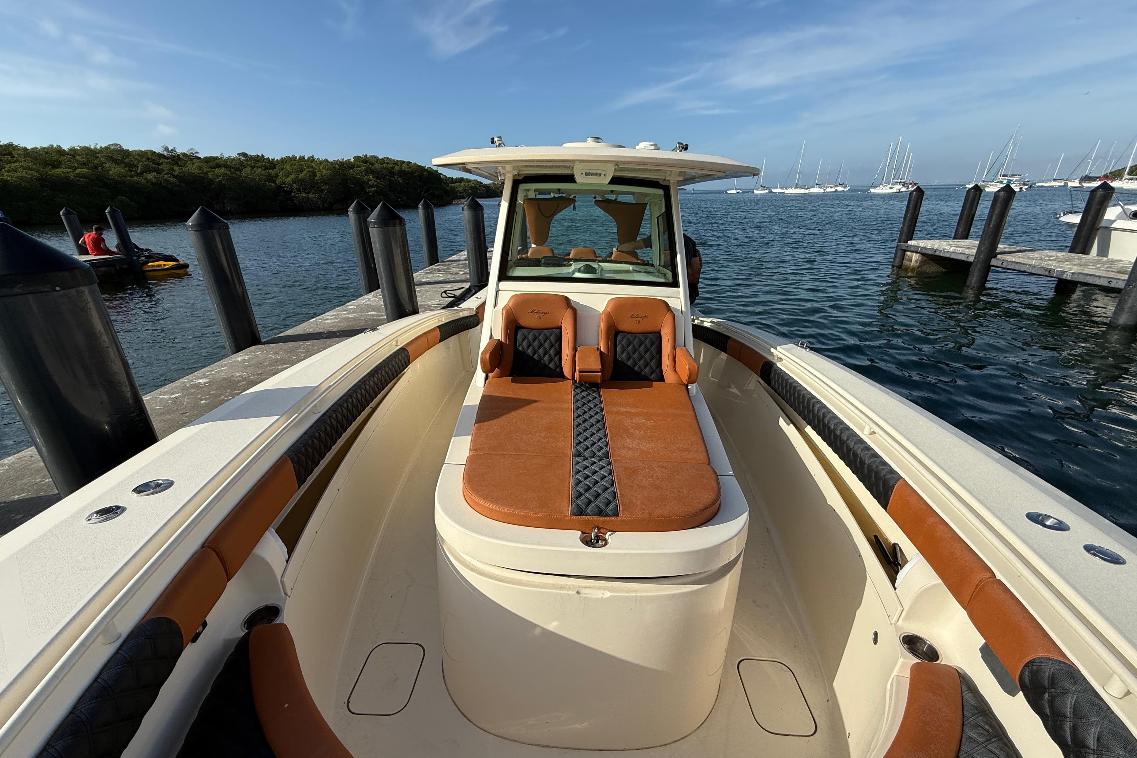 2019 Scout 355 LXF boat docked, featuring luxurious seating and sleek design.