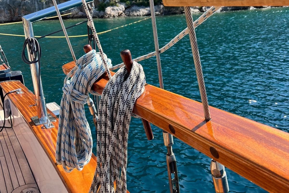 Polished wood deck of 1993 Custom Sailing Yacht Ocean Pure with coiled ropes.