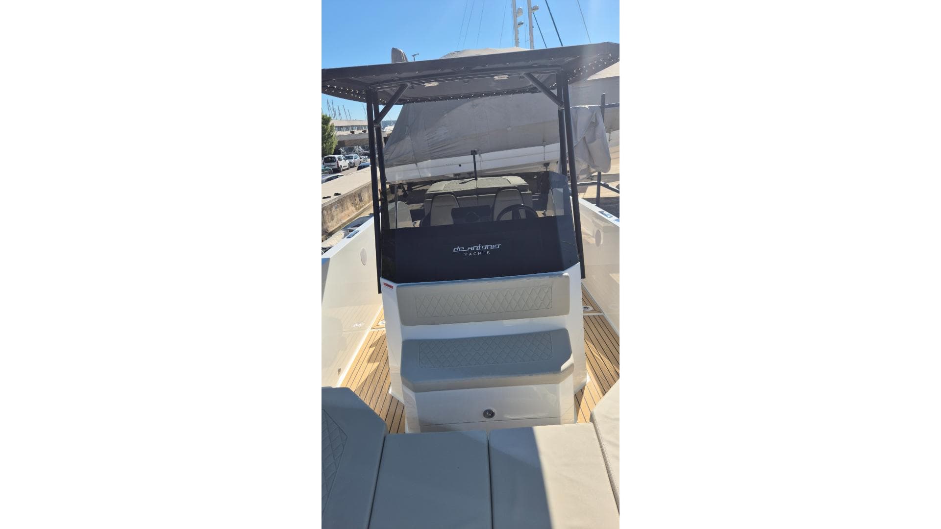 2024 De Antonio Yachts e23 Open, sleek design, modern seating, docked under clear skies.