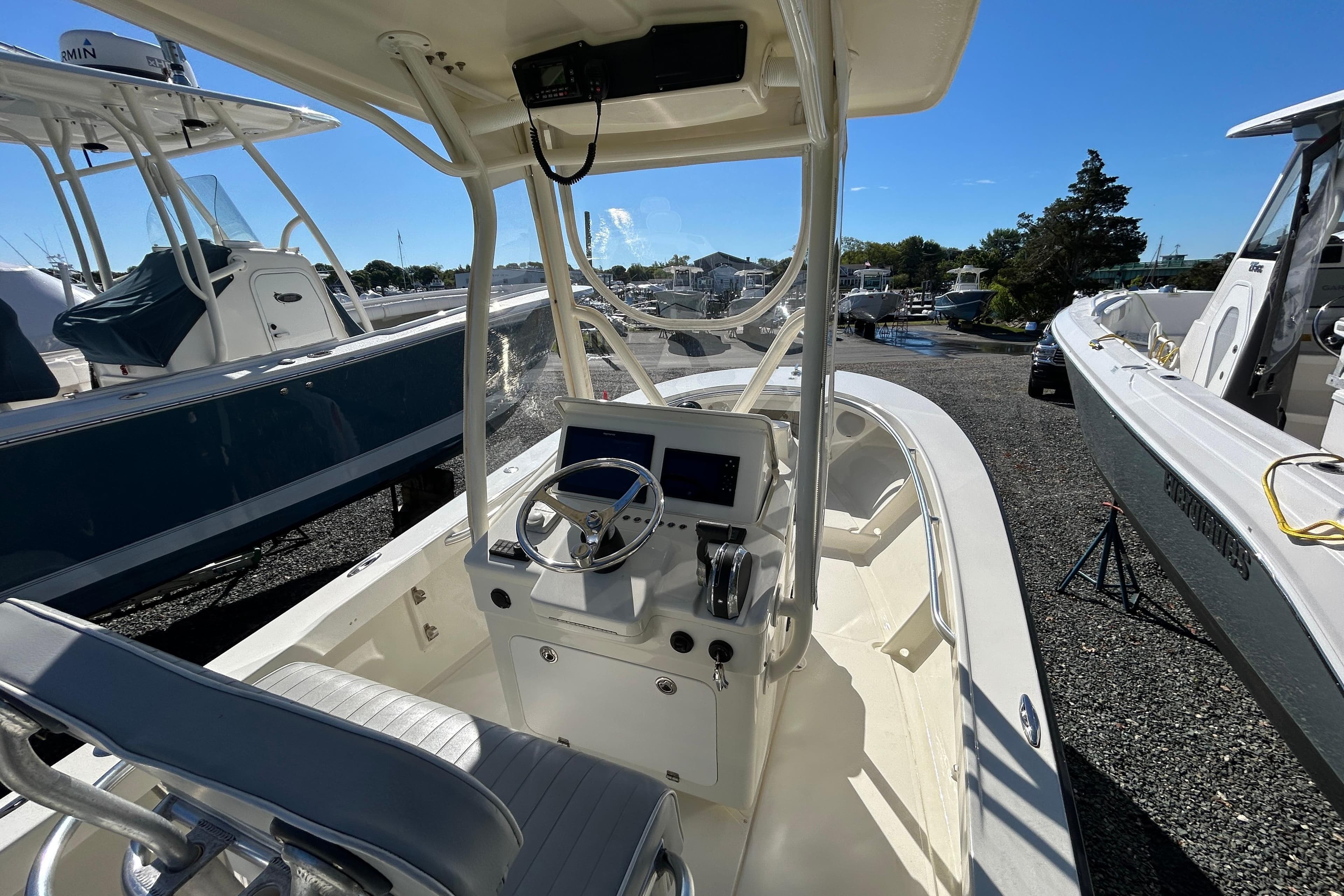 2004 Gloucester G-20 boat cockpit with steering wheel and controls, parked outdoors.