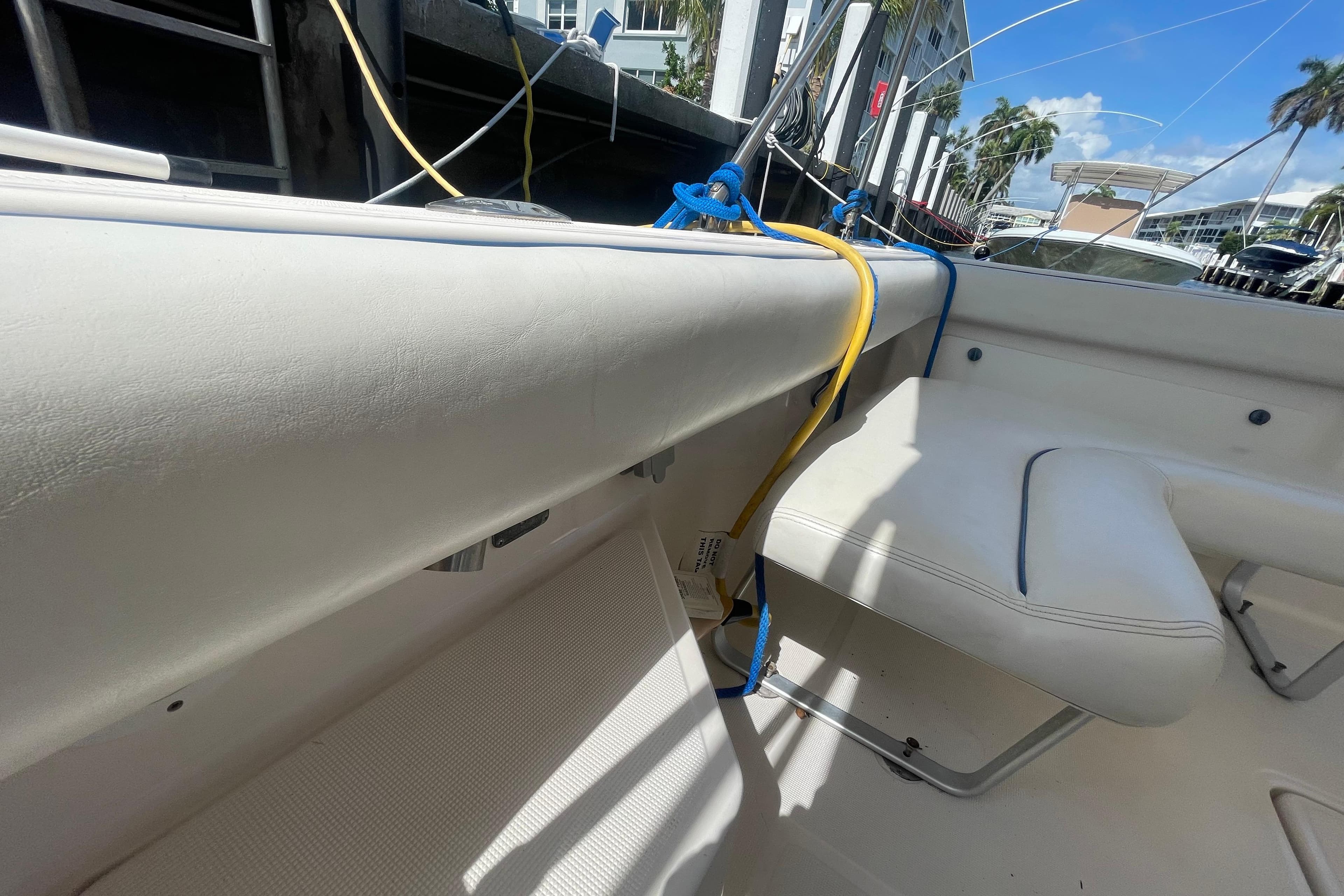 2001 Tiara Yachts 2900 Coronet interior with white seating and colorful ropes.