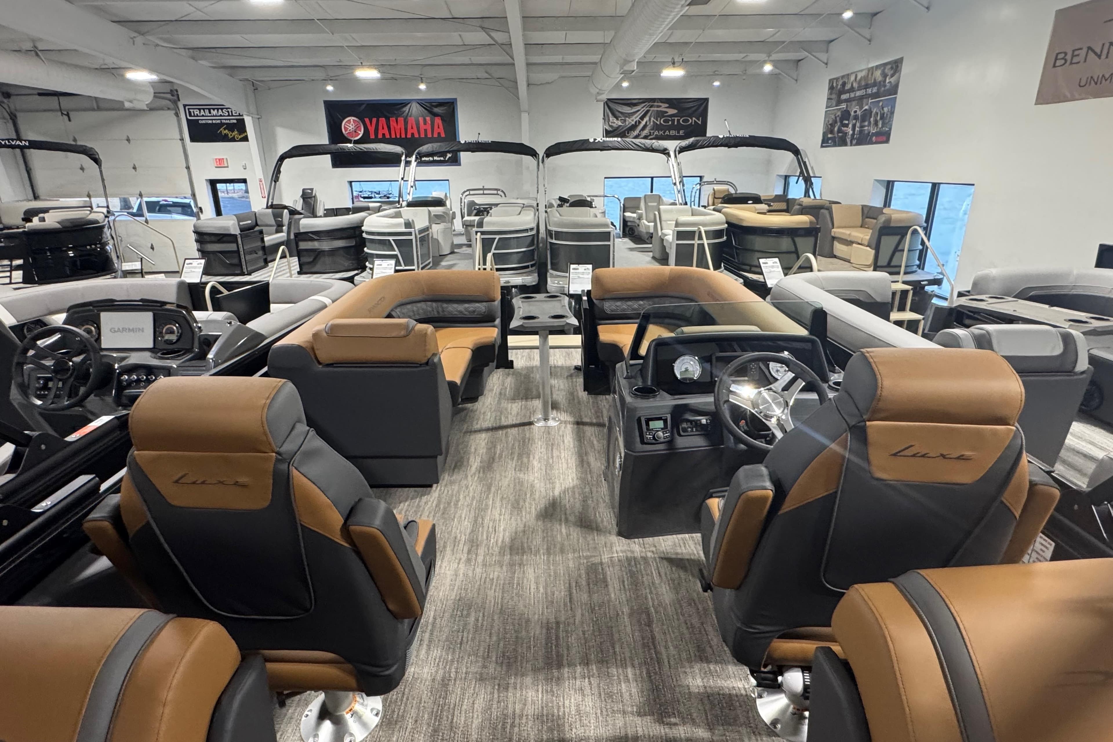 2026 Bennington 22 SSR Luxe pontoon boat interior with luxurious seating and modern dashboard.