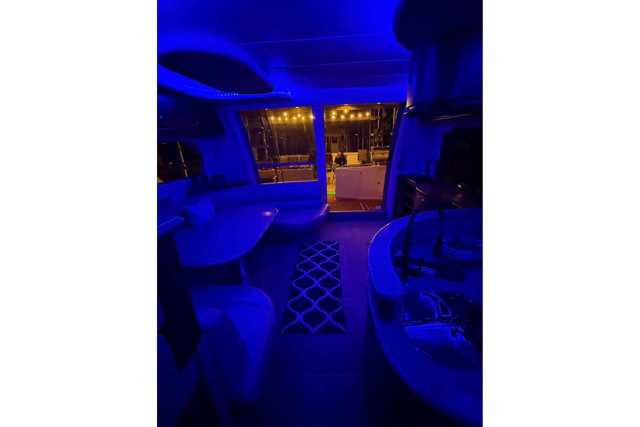 1999 Maxum 4600 SCB yacht interior with blue ambient lighting and modern furnishings.