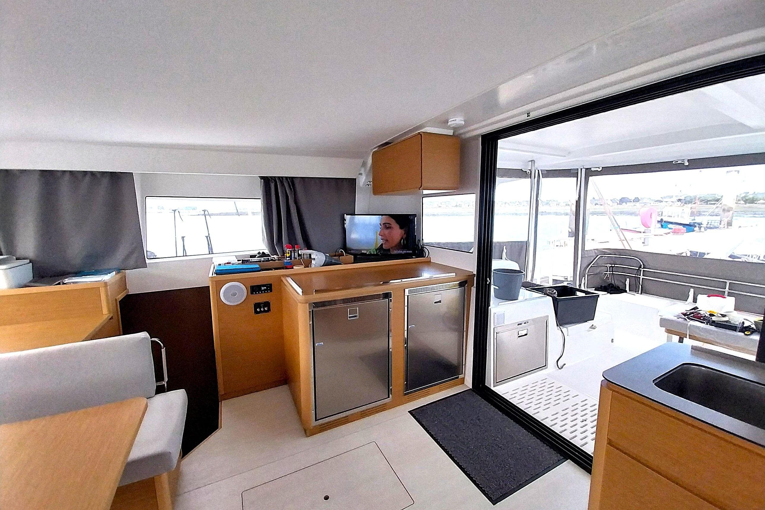 Interior of 2024 Excess 14 catamaran, featuring modern kitchen and spacious seating area.