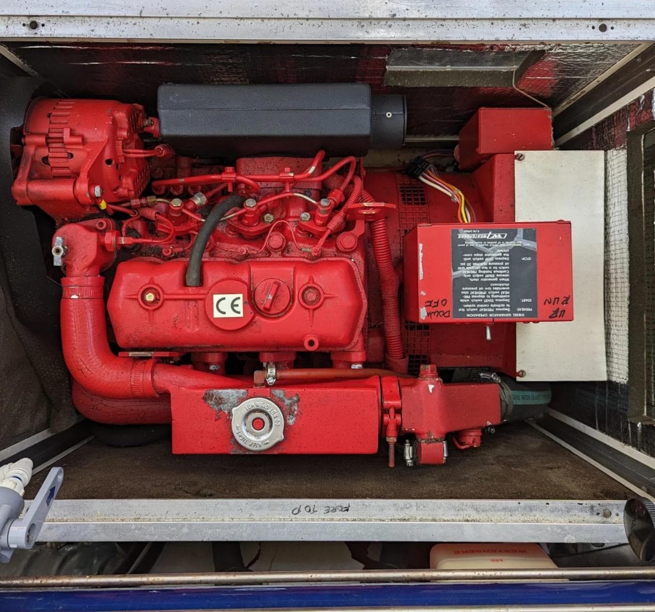 Red engine of a 1999 Maxum 4100 SCB boat, detailed view.
