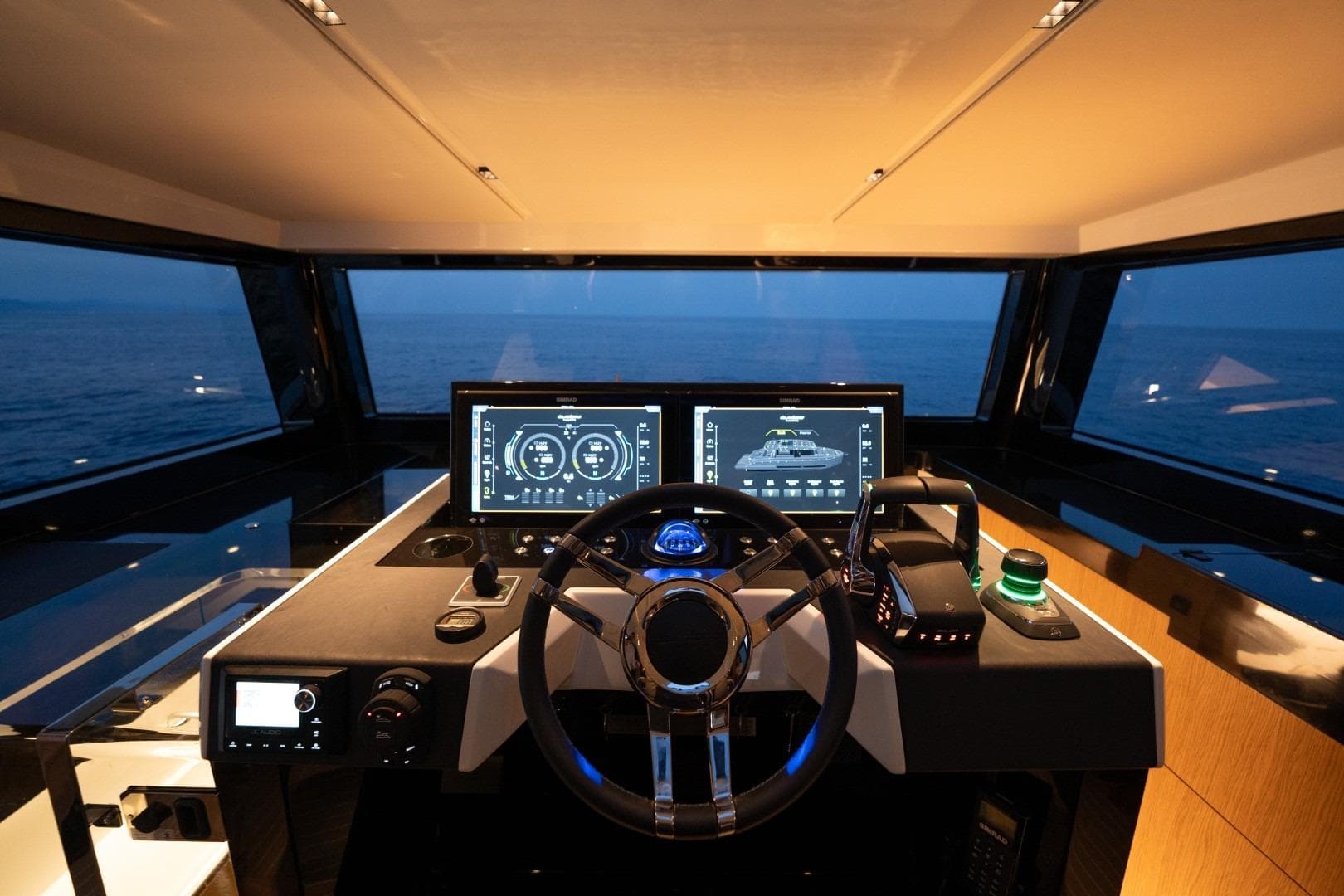 Helm of 2026 De Antonio Yachts D60 with advanced navigation screens at sea.