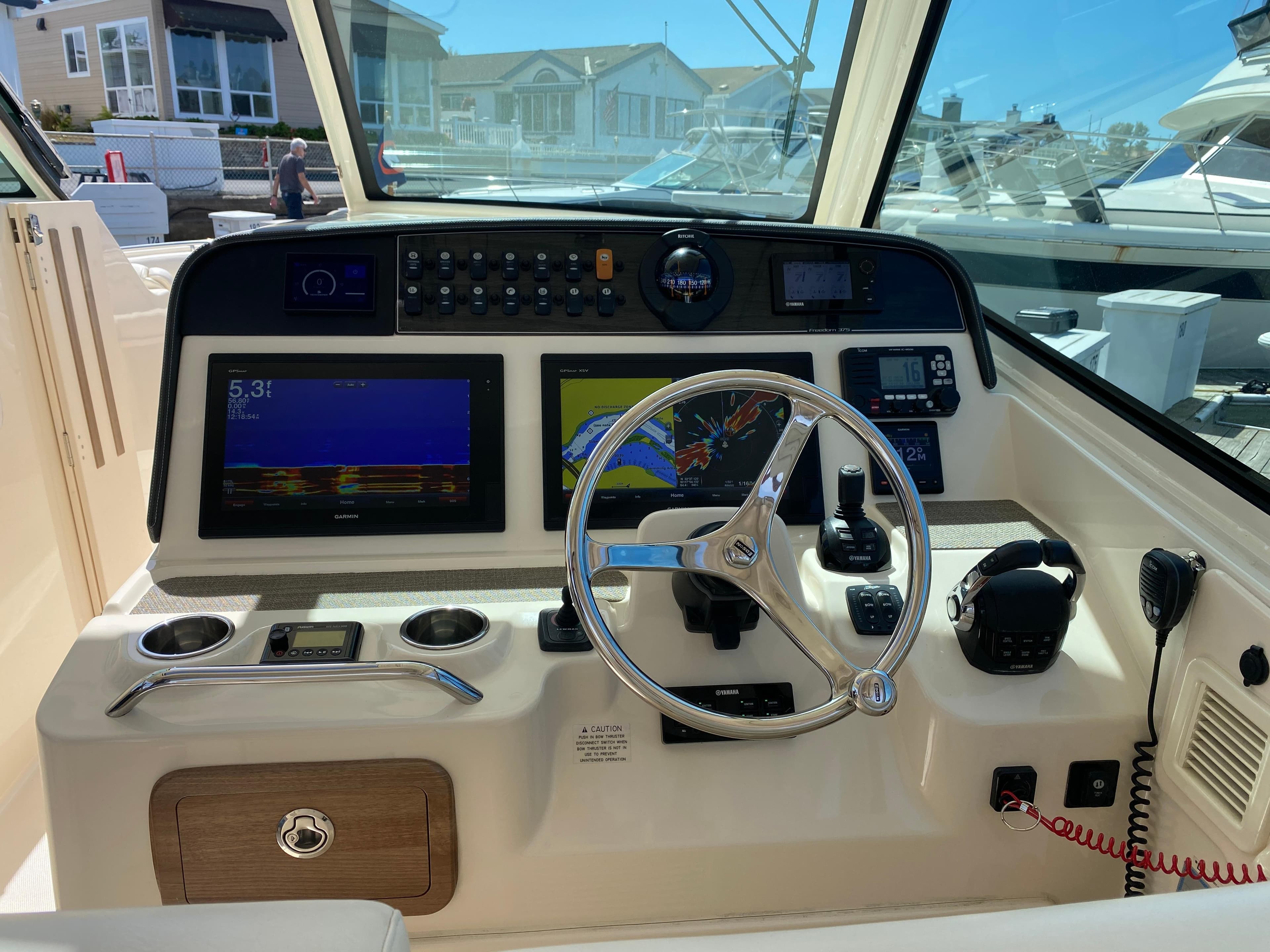 2017 Grady-White Freedom 375 helm with navigation screens and steering wheel.