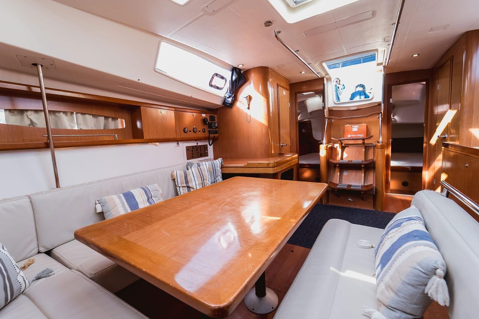 Spacious interior of 2009 Beneteau Oceanis 46 sailboat with wooden furnishings and cozy seating.