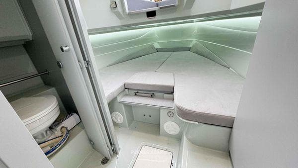 2024 XO Boats DFNDR 9 cabin interior with bed and toilet.