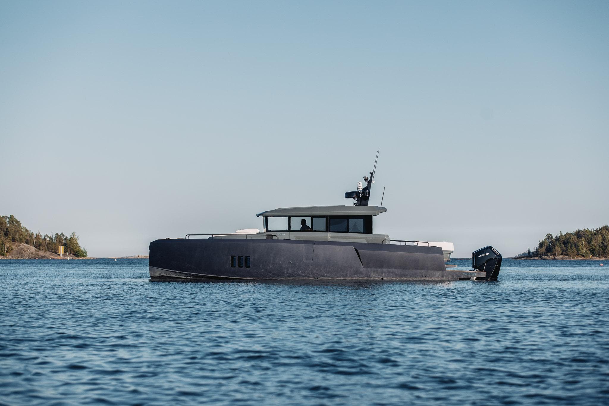 2026 XO Boats EXPLR 44 cruising on calm waters under a clear sky.
