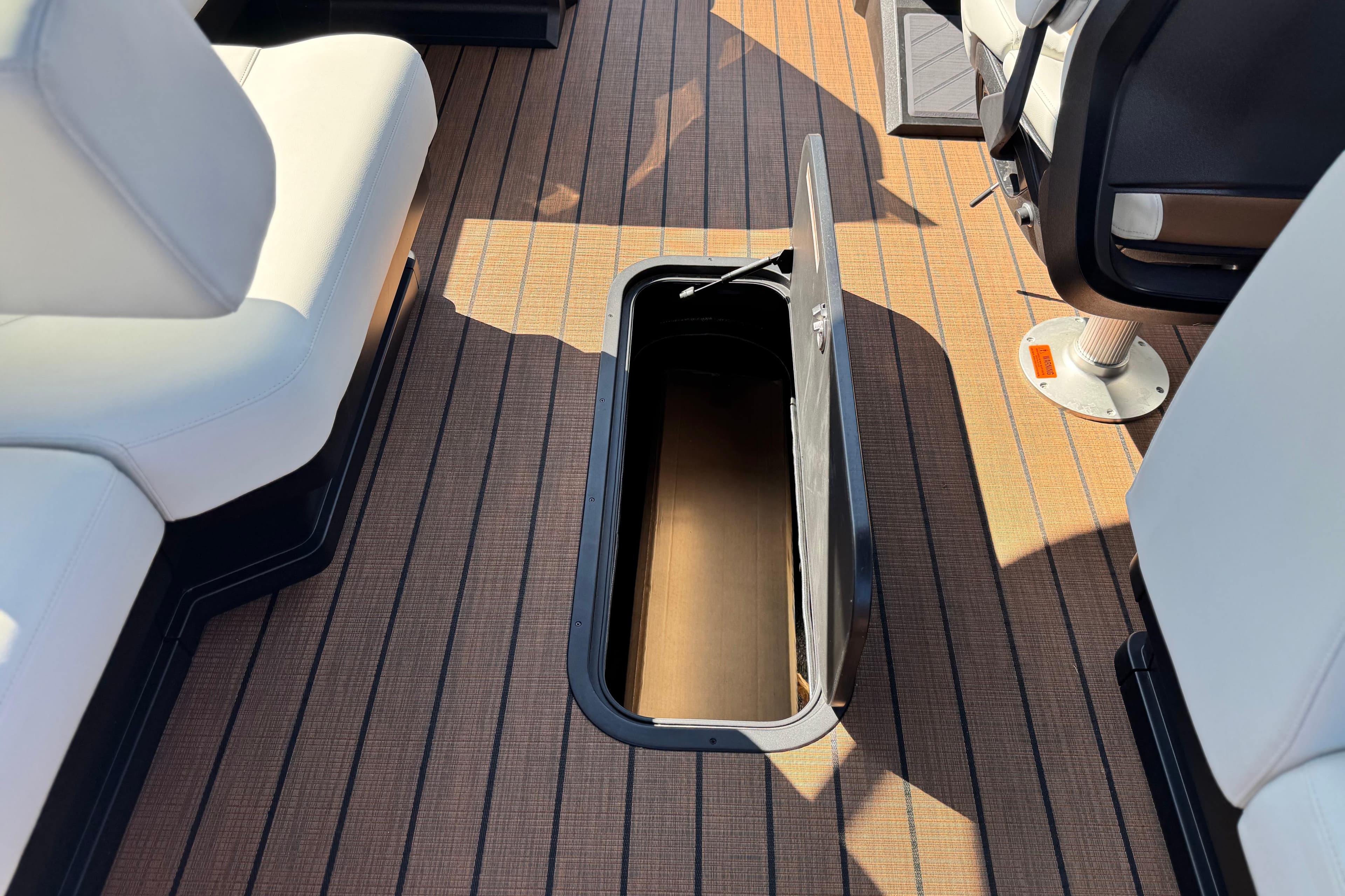 2026 Manitou EXPLORE 22 boat interior with open storage compartment on deck.