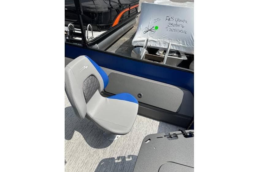 2026 Bennington 23 SF Family boat with blue and gray seating, docked.