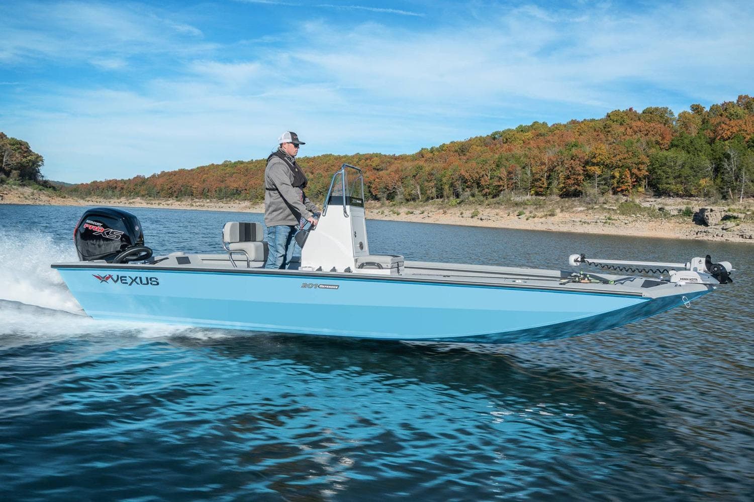 Manufacturer Provided Image: 2026 Vexus Defender 201 boat cruising on a scenic lake with autumn foliage.