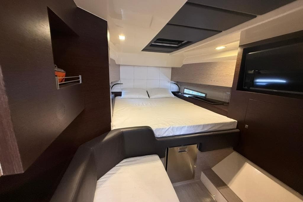 Luxurious cabin interior of 2017 SACS Rebel 47 yacht with bed and seating area.