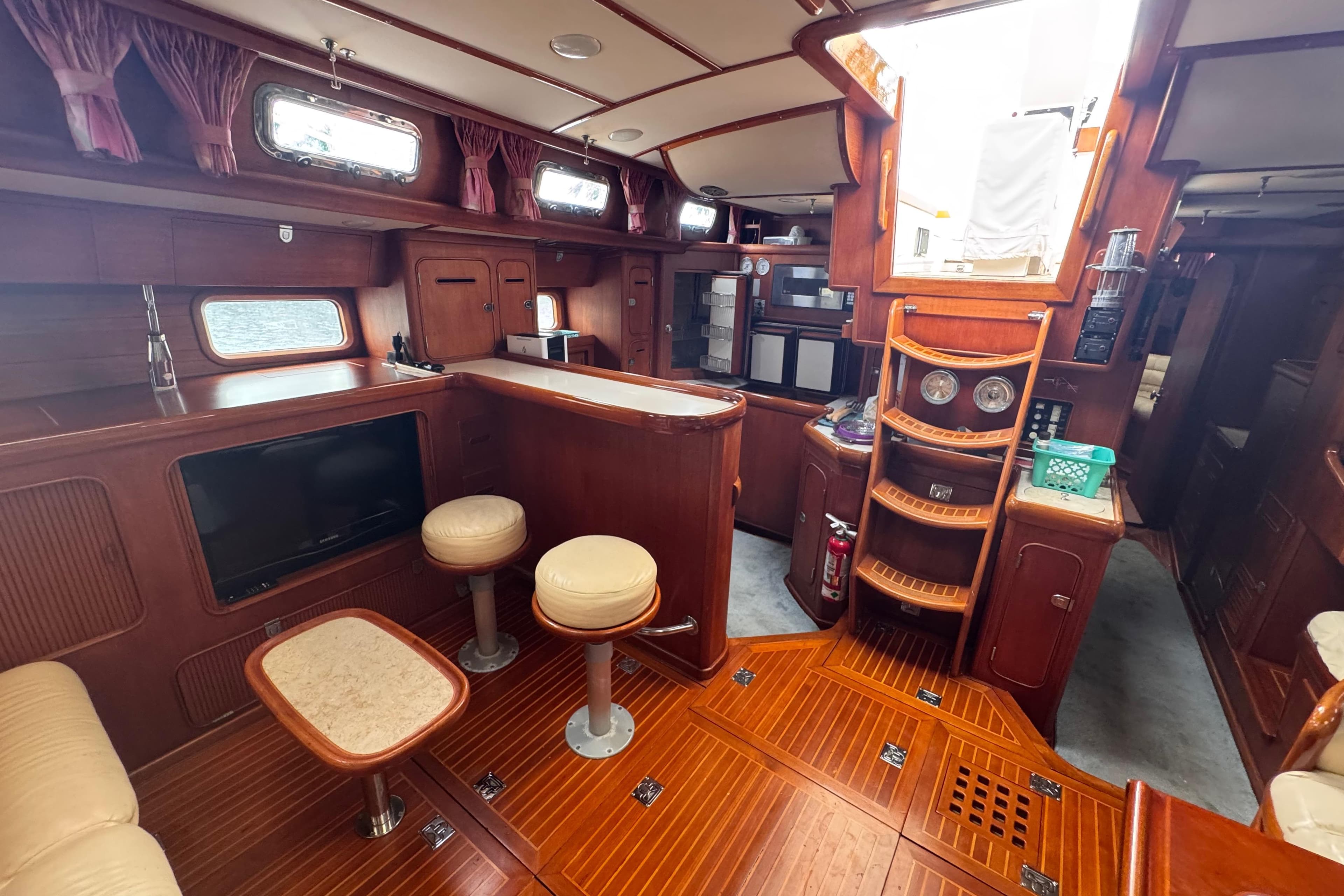 Luxurious 1989 Little Harbor Sloop 58' interior with elegant wood finish and seating area.