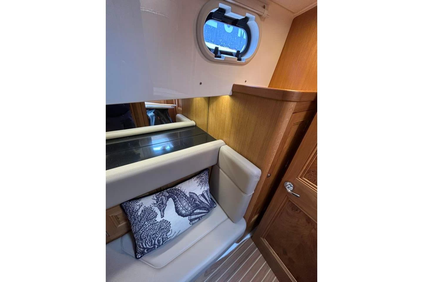 Luxurious interior of 2019 Cockwells Duchy 35 yacht with elegant seating and decorative pillow.