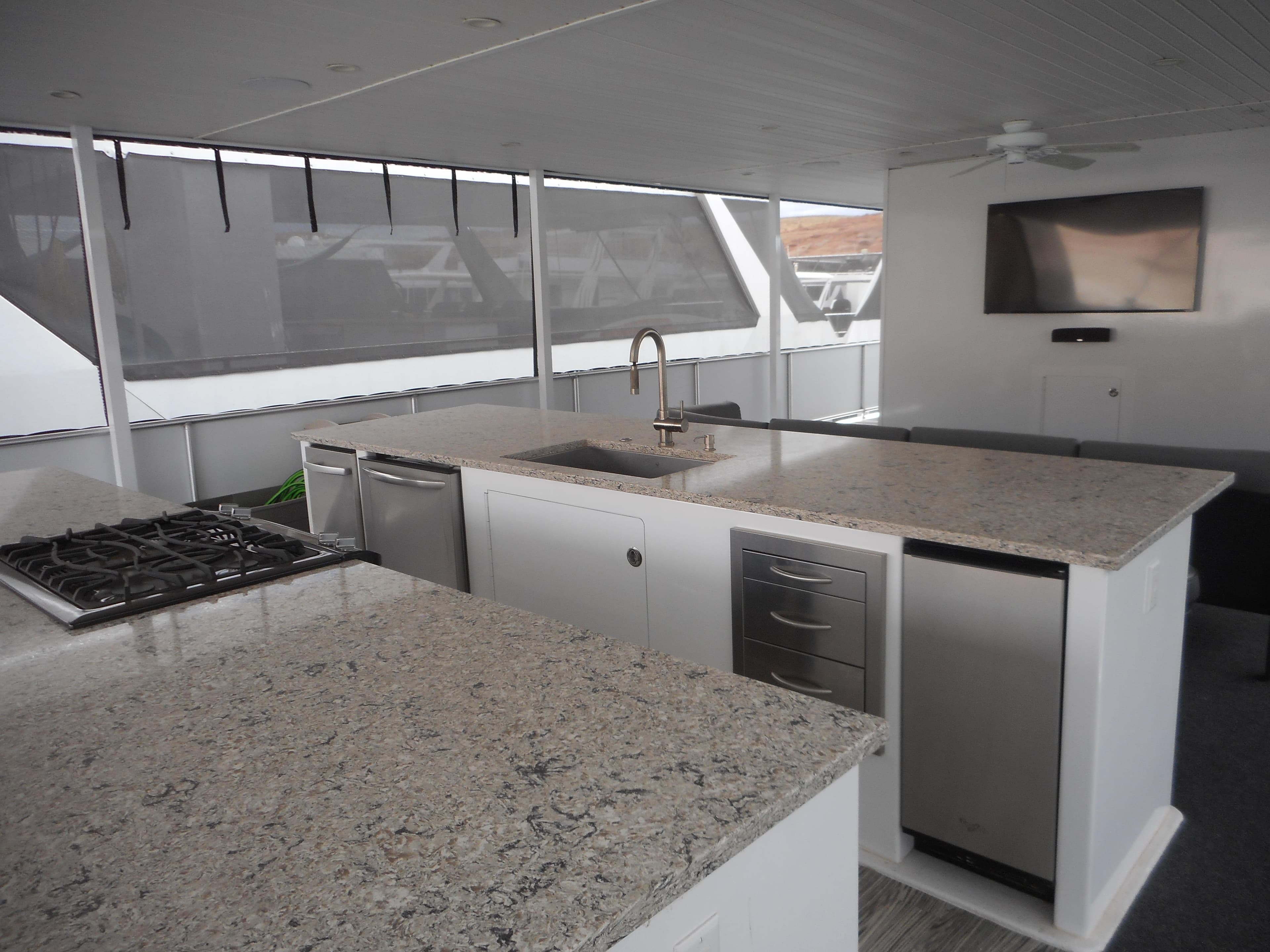 Modern kitchen on 2017 Adonia Liquidity Trip 5 yacht with granite countertops and stainless steel appliances.